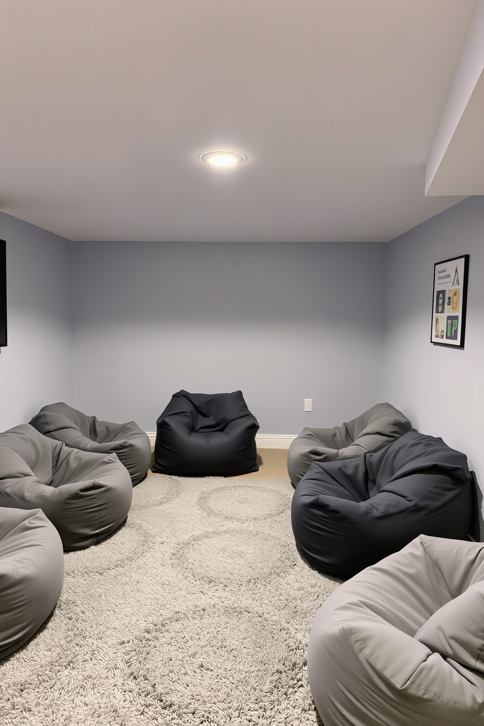 A cozy game room featuring soft gray bean bags arranged for relaxed seating. The walls are painted in a light gray hue, complemented by a plush area rug in a darker shade of gray.