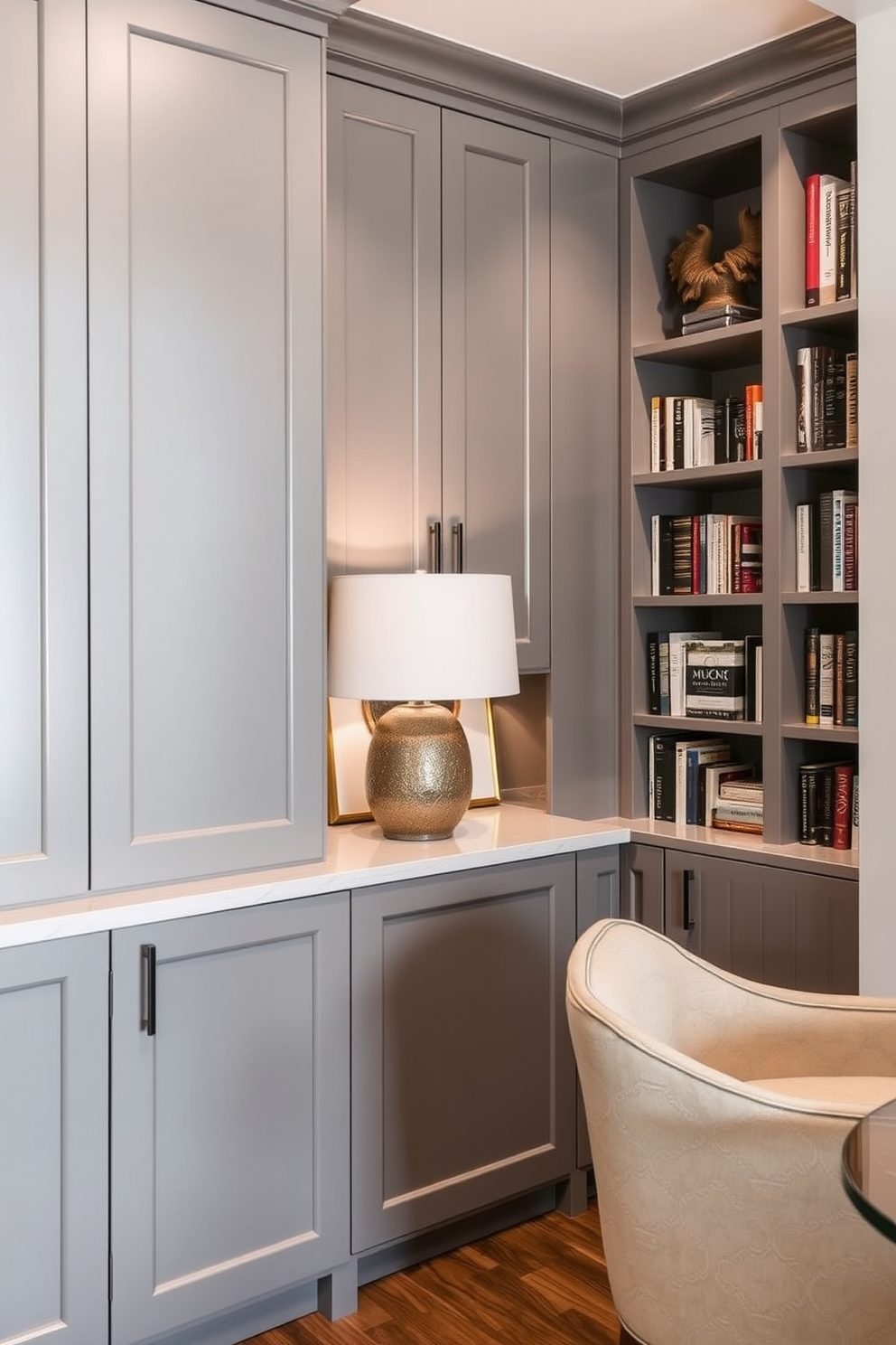 A contemporary home library featuring sleek gray cabinetry that blends seamlessly with the modern aesthetic. The space is enhanced by built-in shelves filled with books and decorative items, creating a sophisticated yet inviting atmosphere.