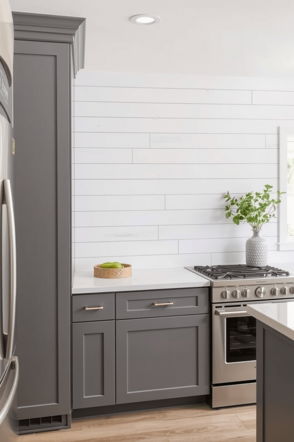 Light gray shiplap walls create a textured backdrop for a modern kitchen. The cabinetry features sleek gray finishes complemented by stainless steel appliances and minimalist hardware.