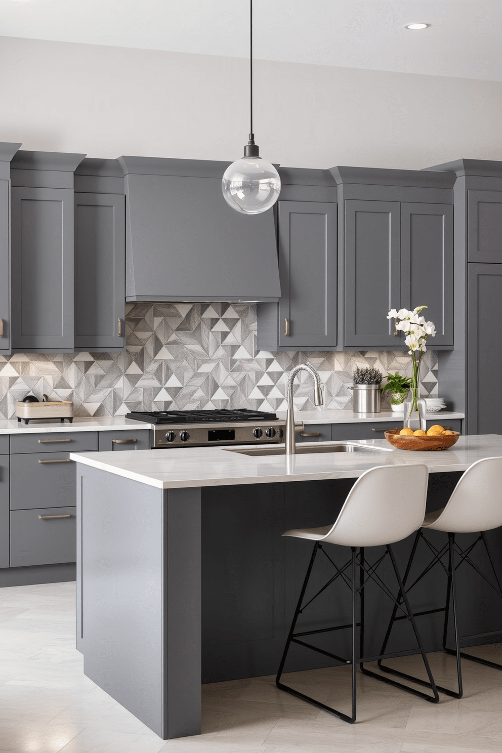 A modern gray kitchen featuring sleek cabinetry and geometric tile patterns on the backsplash. The island is topped with a polished quartz surface, and stylish bar stools provide seating for casual dining.