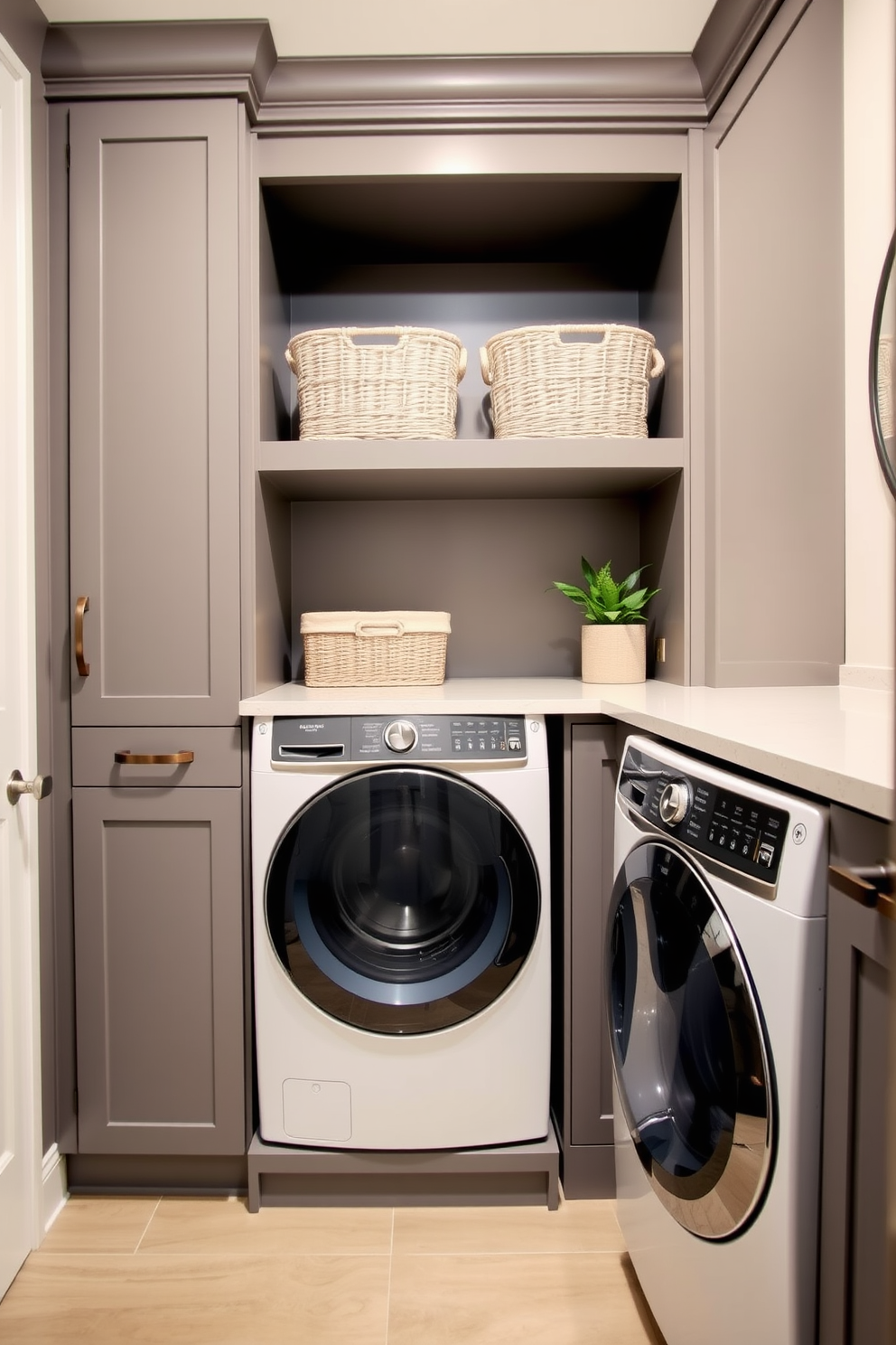 A modern laundry room featuring built-in storage solutions designed for maximum organization. The cabinetry is a sleek gray finish, with open shelving above for easy access to essentials and a countertop for folding clothes. The space includes a stacked washer and dryer seamlessly integrated into the cabinetry. Decorative baskets are placed on the shelves, and a small potted plant adds a touch of greenery to the room.