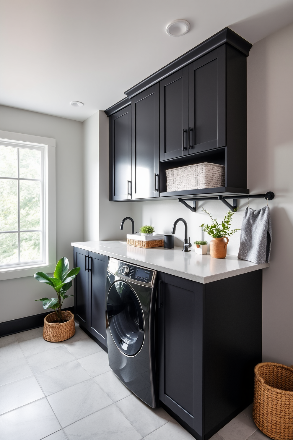 A modern laundry room featuring light gray walls complemented by dark cabinetry and accents. The space includes a sleek washer and dryer stacked for efficiency, with a countertop above for folding clothes. Natural light streams in through a large window, illuminating the room and highlighting the stylish dark fixtures. Decorative baskets and potted plants add warmth and functionality to the overall design.