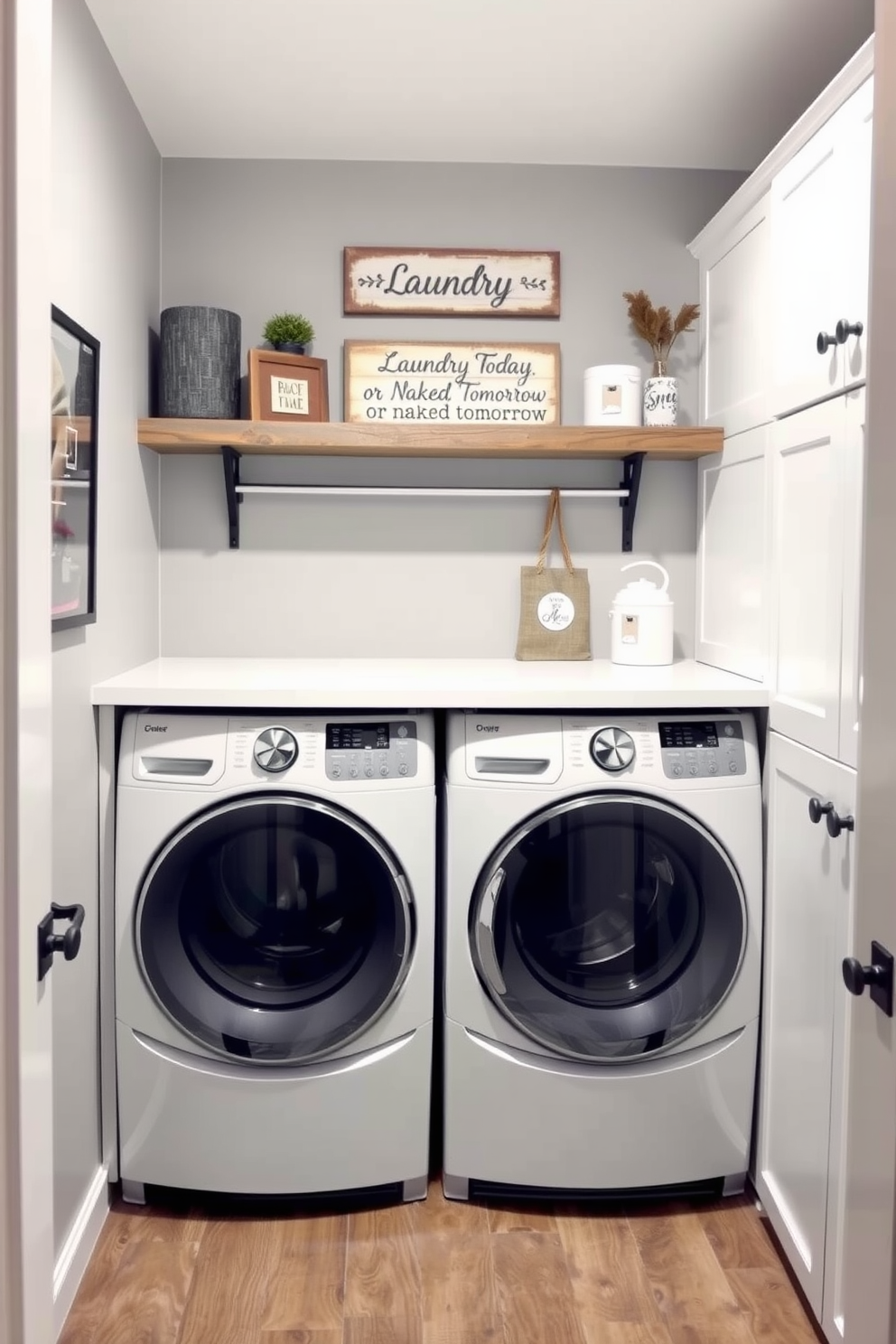 A stylish gray laundry room features decorative signs that add a personal touch to the space. The walls are a soft gray, complemented by white cabinetry and a rustic wooden shelf displaying charming laundry-themed decor. The washing machine and dryer are neatly tucked away, with a countertop above for folding clothes. A playful sign saying 