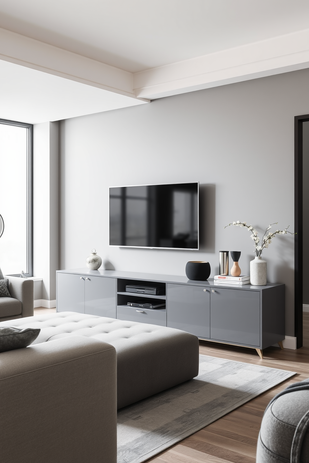 A sleek gray media console sits against the wall, providing ample storage and organization for electronics and accessories. The living room features a harmonious blend of gray tones, with plush seating and stylish decor that creates a modern and inviting atmosphere.