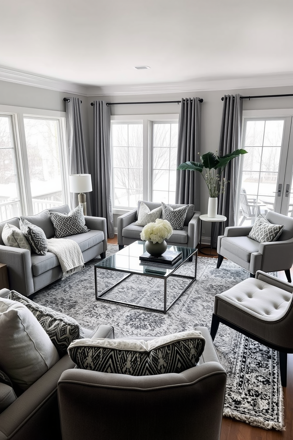 A cozy living room featuring layered gray tones that create depth and warmth. The space includes a plush gray sofa adorned with textured throw pillows and a soft area rug that complements the color scheme. A sleek coffee table made of glass and metal sits in the center, surrounded by stylish accent chairs. Large windows allow natural light to flood the room, highlighting the various shades of gray used in the decor.