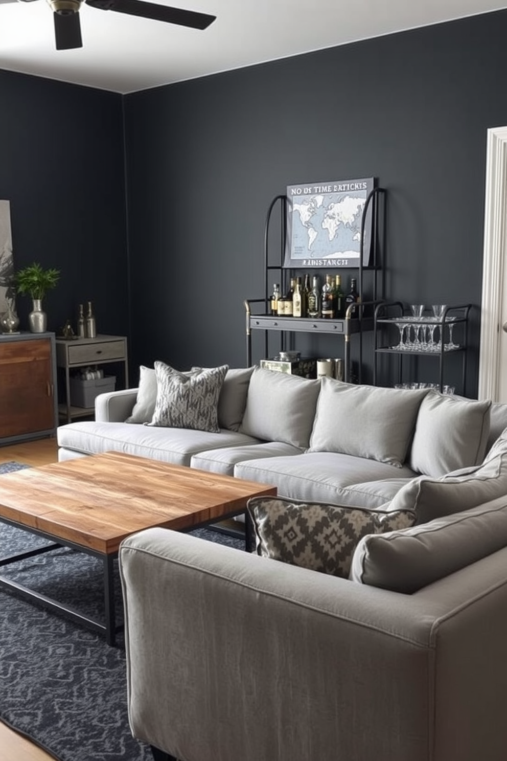 A stylish man cave featuring industrial-style gray furniture pieces. The space is adorned with a large sectional sofa in a soft gray fabric, paired with a reclaimed wood coffee table that adds warmth to the room. The walls are painted in a deep charcoal color, enhancing the industrial vibe. A vintage metal bar cart stands in one corner, stocked with an assortment of spirits and glassware for entertaining guests.