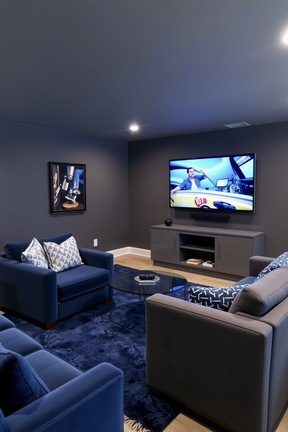 A stylish man cave featuring a gray and blue color scheme. The walls are painted a deep gray, complemented by plush blue seating and sleek gray furniture. In one corner, a large flat-screen TV is mounted above a modern gray media console. A blue area rug anchors the seating area, adding warmth and texture to the space.