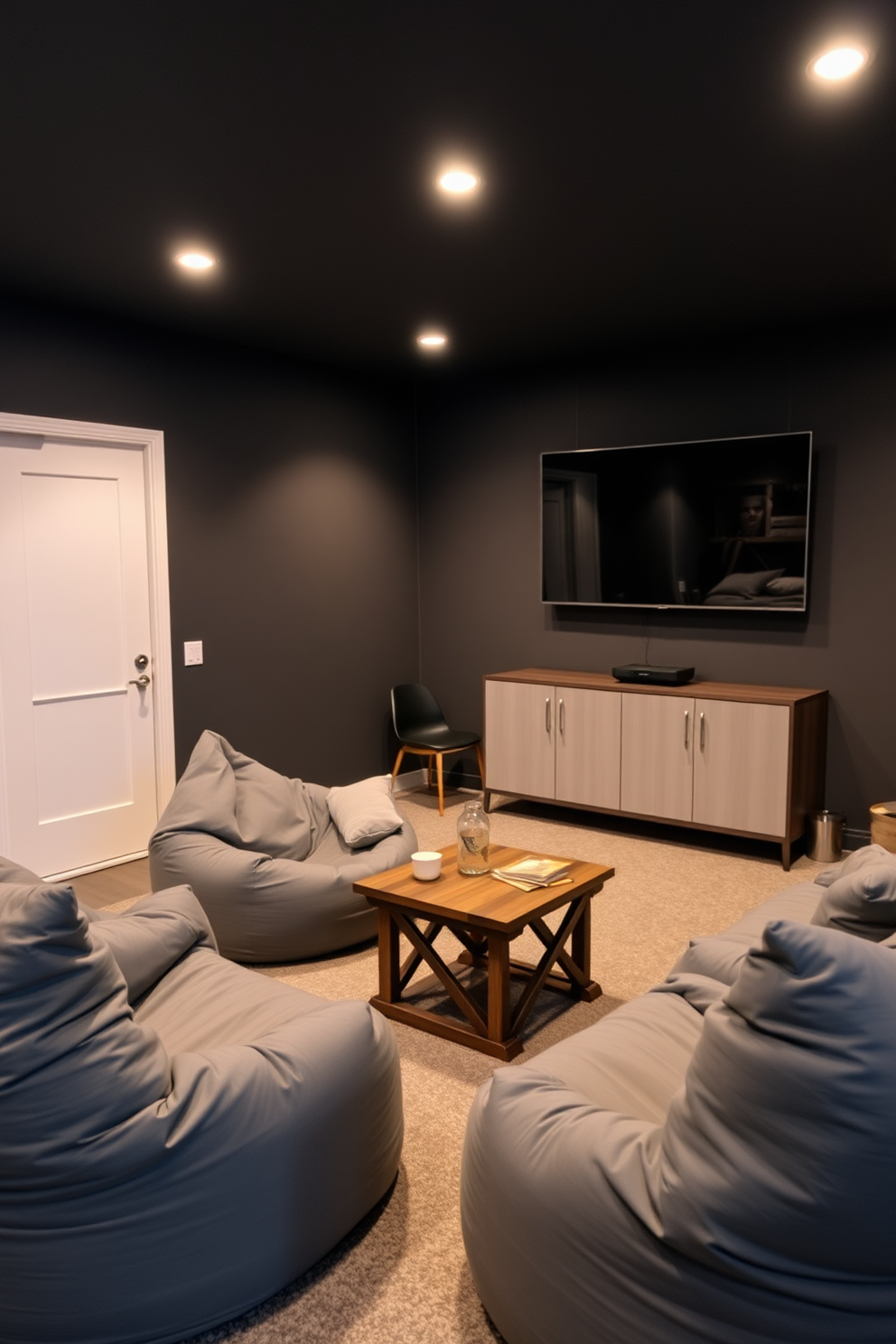 A cozy man cave featuring gray bean bags for casual seating. The walls are painted in a deep charcoal color, complemented by soft ambient lighting that creates a warm atmosphere. In one corner, a large flat-screen TV is mounted above a sleek media console. A small coffee table with a rustic finish sits in front of the seating area, perfect for snacks and drinks.