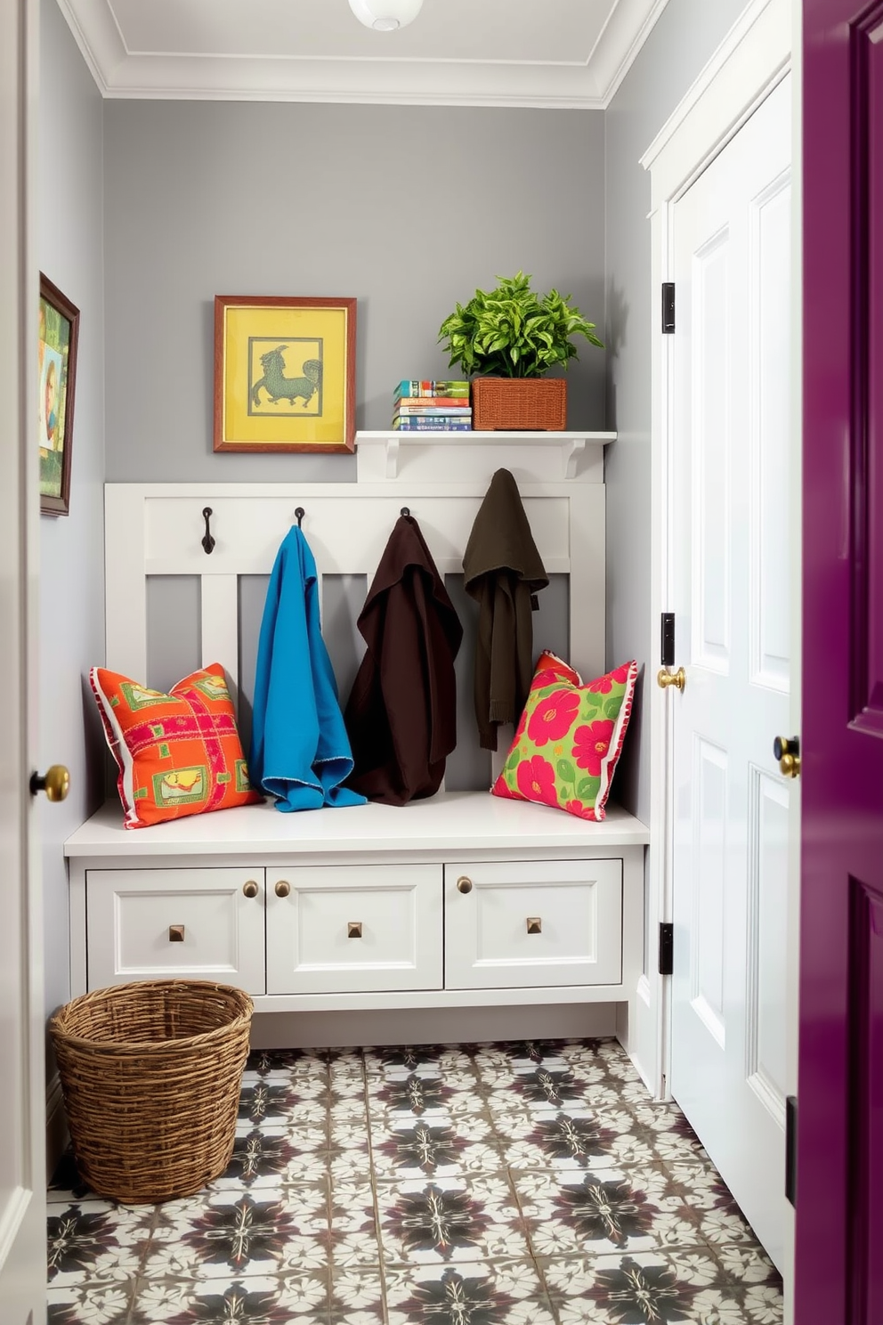 Bright gray paint creates a serene backdrop for a mudroom filled with vibrant accents. The space features a built-in bench with colorful cushions and hooks for coats, paired with patterned floor tiles that add a playful touch.