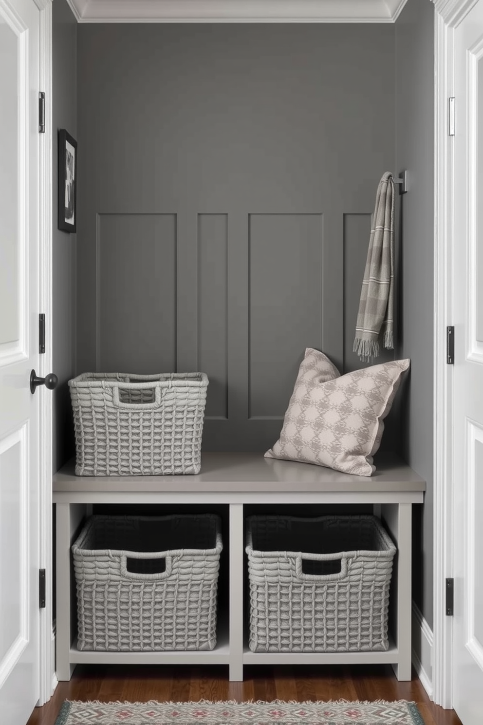 Chic gray storage baskets are neatly arranged in a stylish mudroom, providing a functional yet elegant solution for organizing everyday items. The mudroom features a combination of gray walls and a sleek bench, creating a welcoming space that balances practicality with modern aesthetics.