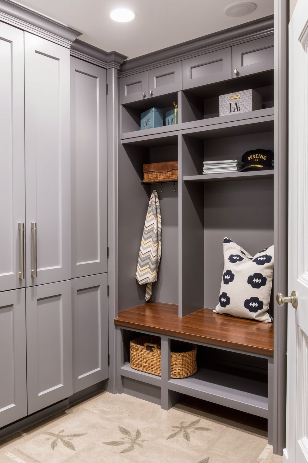 Modern gray cabinetry with sleek hardware creates a clean and functional space. The mudroom features built-in benches and open shelving for easy organization and stylish storage.