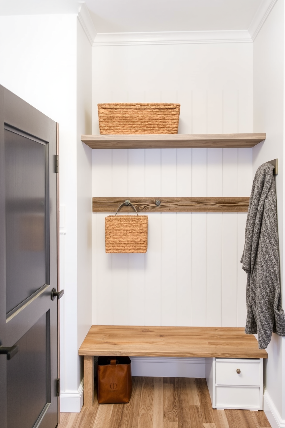 A cozy mudroom featuring rustic gray reclaimed wood shelves that provide both storage and style. The walls are painted in a soft white hue, complementing the natural texture of the wood and creating a warm, inviting atmosphere.