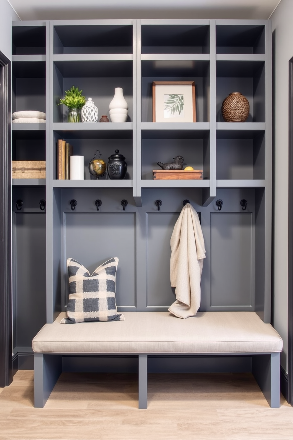 A modern mudroom featuring open gray shelving designed for displaying decorative items. The space includes a bench with soft cushions and hooks for hanging coats, creating an inviting and functional entryway.