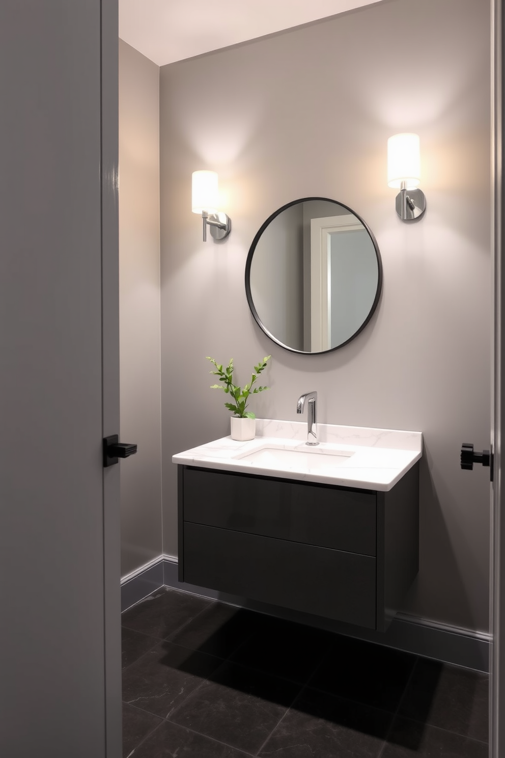 Elegant sconces illuminate the gray powder room, casting a warm glow on the sleek, minimalist decor. The walls are painted in a soft gray hue, complemented by a stylish floating vanity with a white marble countertop. A large round mirror with a thin black frame hangs above the vanity, reflecting the light from the sconces. The floor features dark ceramic tiles, adding depth to the overall design while a small potted plant brings a touch of greenery to the space.