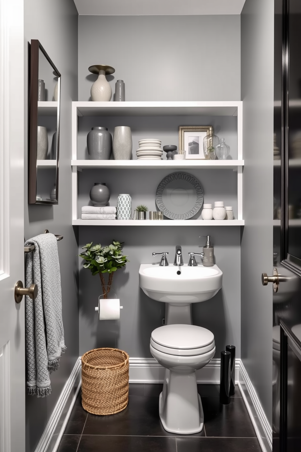 A stylish gray powder room featuring open shelving adorned with various decorative items in shades of gray. The walls are painted in a soft gray hue, and the floor is covered with a sleek dark tile that complements the overall design.