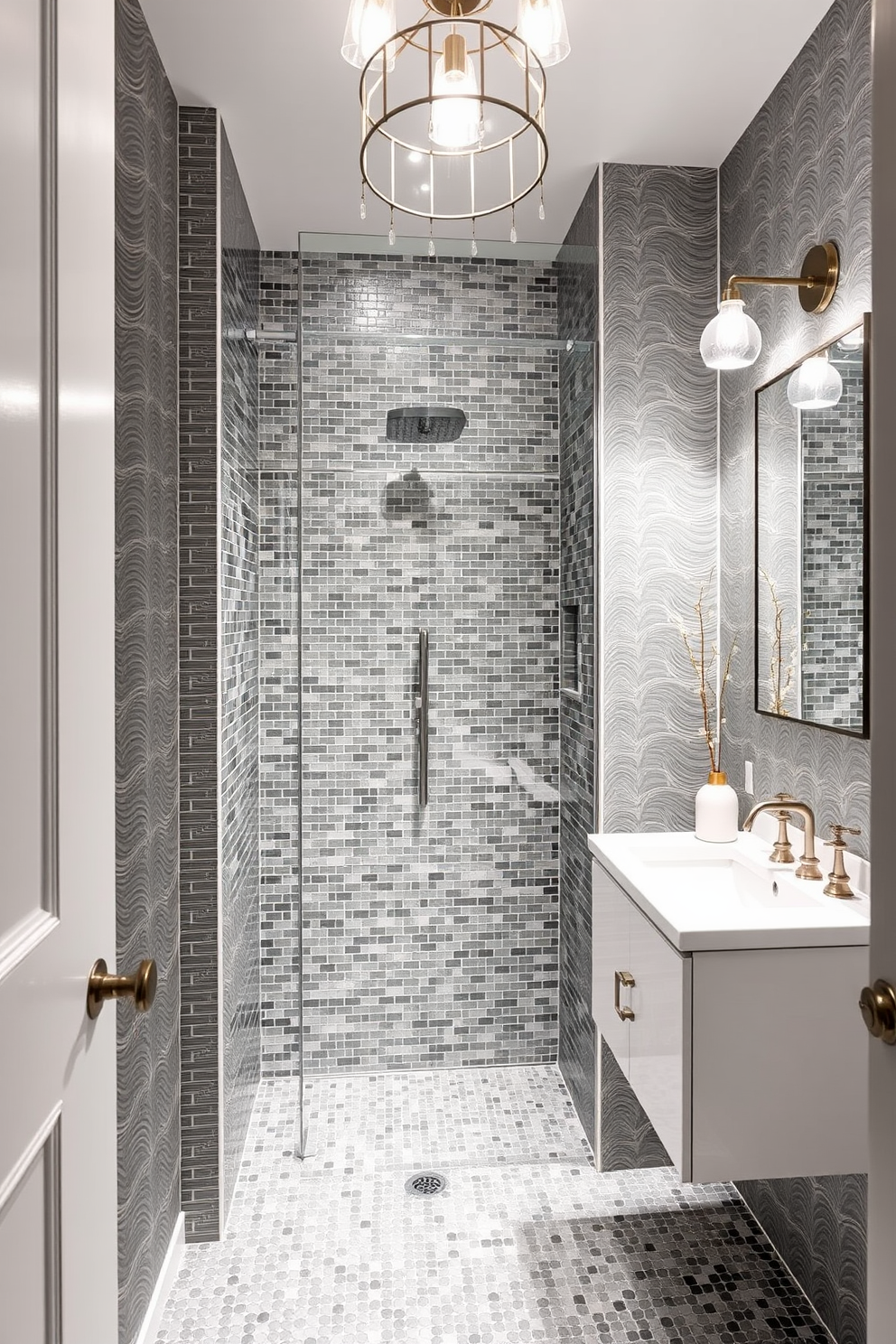 A stylish powder room featuring gray mosaic tiles that create a visually striking shower area. The walls are adorned with elegant gray wallpaper, complemented by a sleek white vanity and modern fixtures. The lighting is soft and inviting, with a chic pendant light hanging above the sink. A minimalist mirror reflects the sophisticated design, while decorative accents add a touch of warmth to the space.