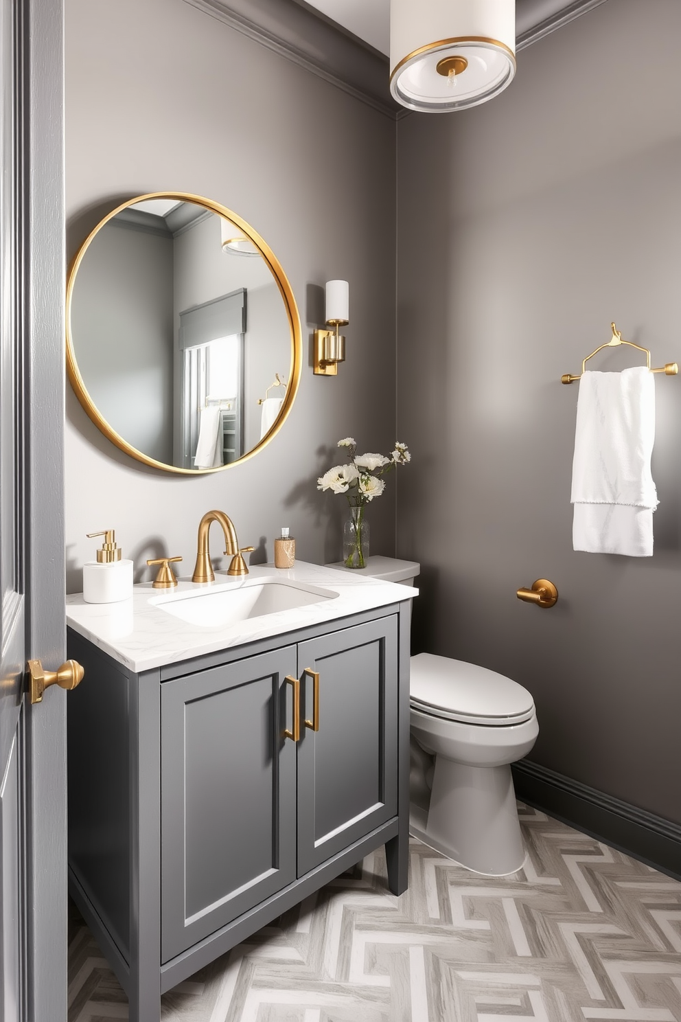 Chic gray and gold decor accents create a luxurious atmosphere in a modern powder room. The walls are painted in a soft gray hue, complemented by gold fixtures and accessories that add a touch of elegance. A sleek gray vanity with a white marble top features a stylish gold faucet and a large round mirror with a gold frame. The floor is adorned with geometric patterned tiles in shades of gray and white, enhancing the contemporary feel of the space.