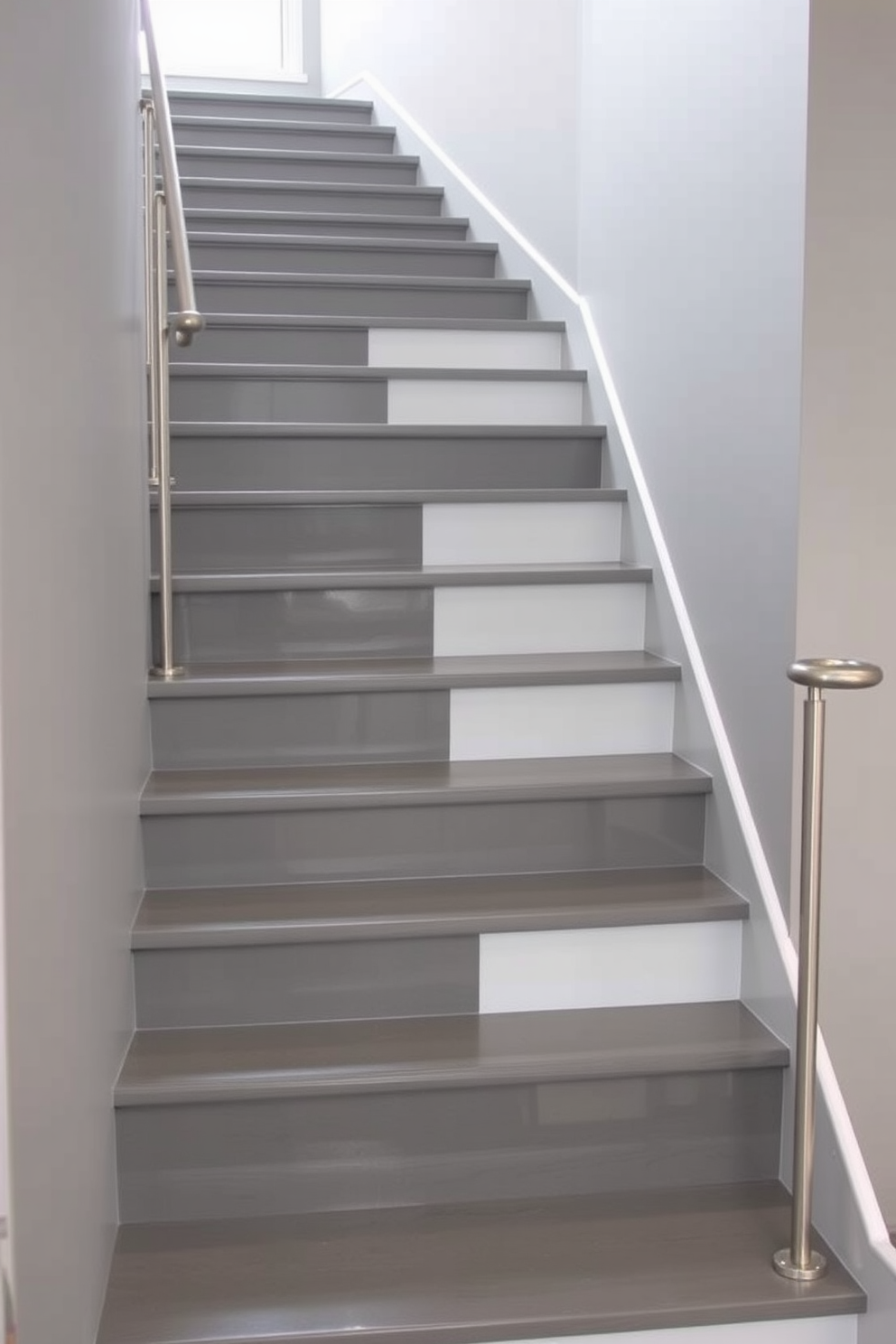 A stunning two-tone gray staircase features a sleek design with contrasting treads that create a striking visual impact. The walls surrounding the staircase are painted in a soft gray, enhancing the modern aesthetic and providing a seamless flow to the space. The treads are a darker shade of gray, offering a bold contrast against the lighter risers, which adds depth and dimension. Elegant stainless steel railings complete the look, providing a contemporary touch while ensuring safety and functionality.