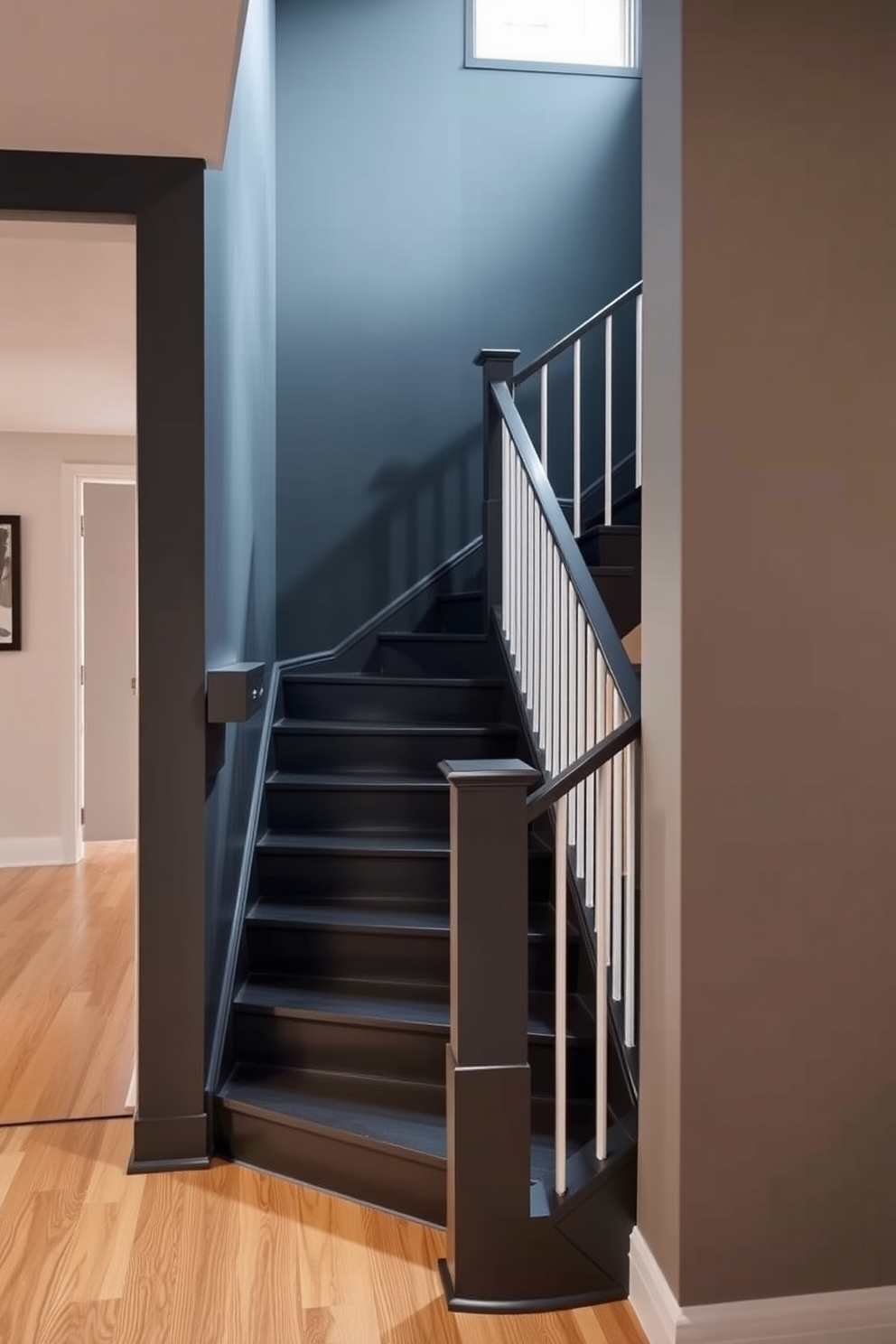 A dark gray painted staircase creates a dramatic focal point in the entryway. The sleek design features minimalist railings and a contrasting light wood floor that enhances the staircase's bold color.