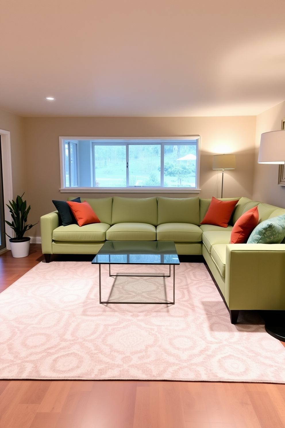 Light green sectional sofa for comfort. The sofa is paired with a sleek glass coffee table and accented by colorful throw pillows. The walls are painted in a soft beige, creating a warm atmosphere. A large area rug with geometric patterns anchors the seating area, adding texture and depth. In the corner, a small indoor plant brings a touch of nature indoors. Ambient lighting from a stylish floor lamp enhances the cozy vibe of the space. Green basement design ideas focus on maximizing natural light and openness. Large windows or glass doors can create an inviting atmosphere, making the basement feel like an extension of the main living area.