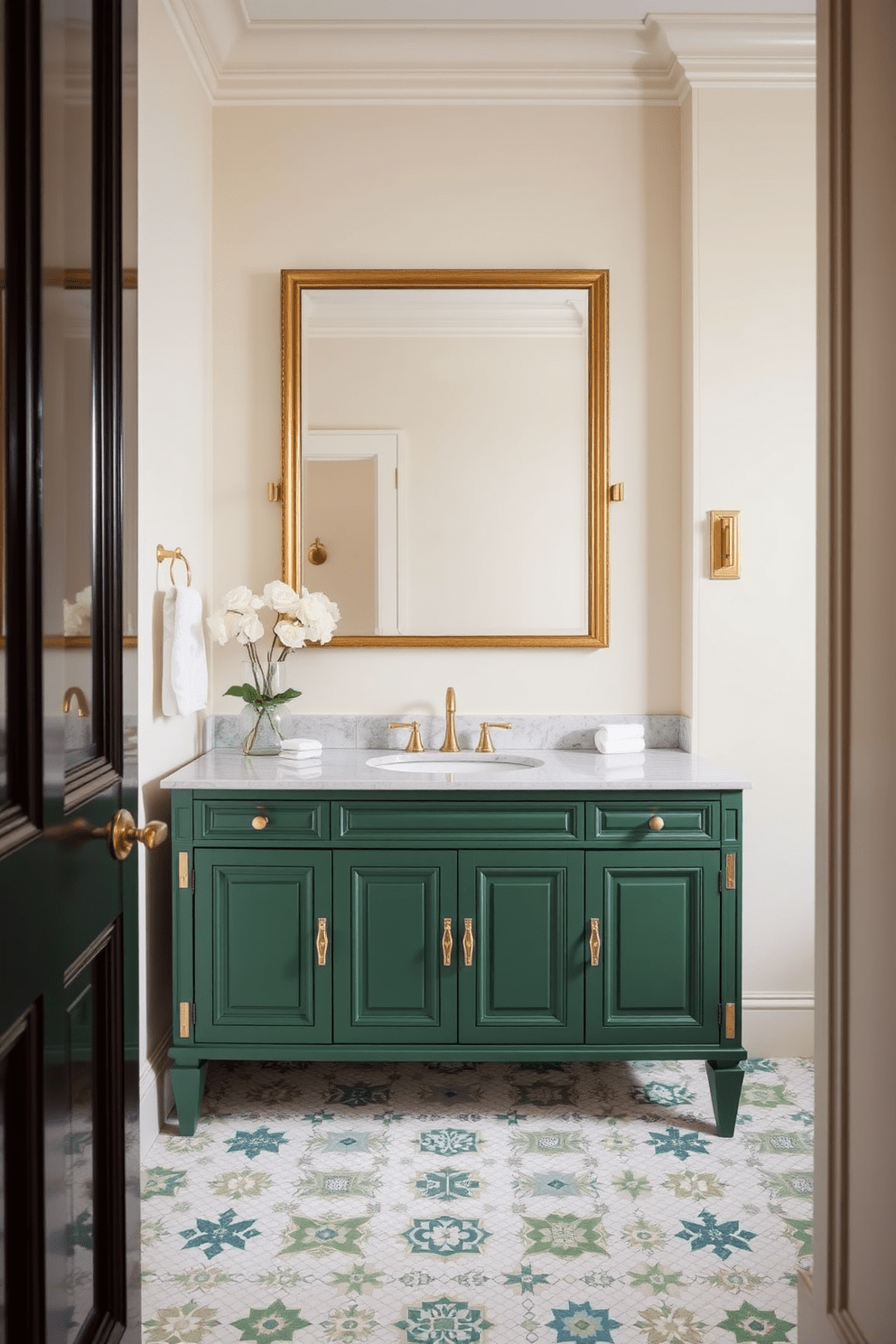 A stunning green vanity with elegant gold hardware accents takes center stage in this luxurious bathroom. The walls are adorned with a soft cream hue, creating a perfect contrast that highlights the vanity's rich color. The floor features a beautiful mosaic of white and green tiles, adding texture and depth to the space. A large rectangular mirror with a gold frame hangs above the vanity, reflecting the exquisite design elements throughout the room.