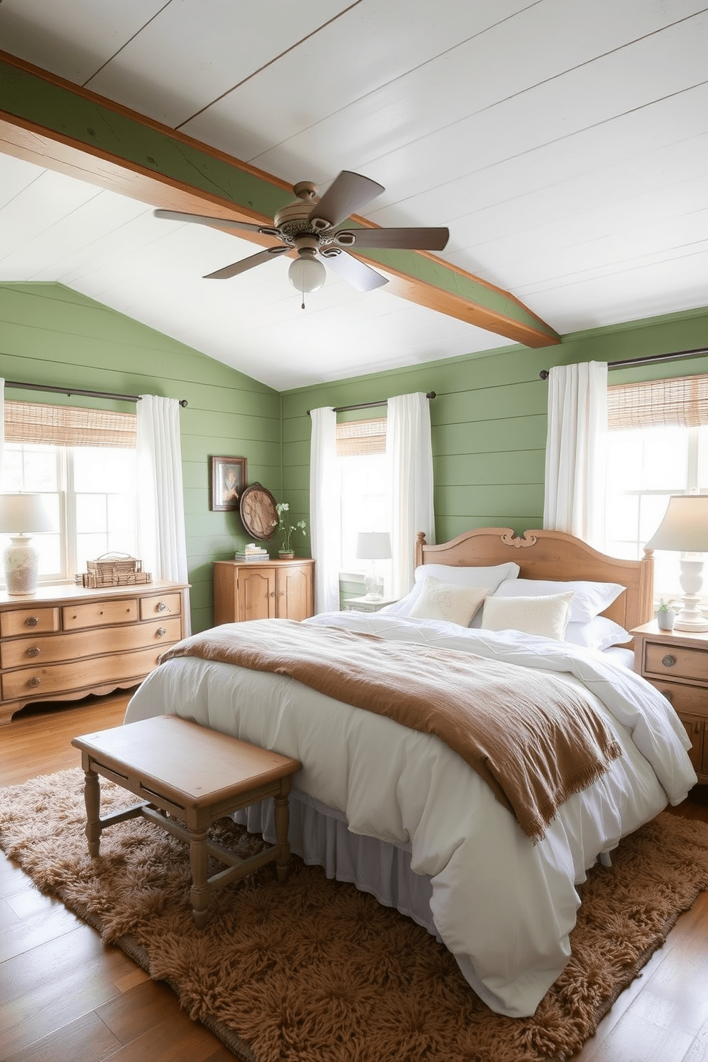 A cozy bedroom featuring cottage style green shiplap walls that create a warm and inviting atmosphere. The room is accented with soft white bedding and rustic wooden furniture, including a vintage dresser and bedside tables. Natural light floods the space through large windows adorned with sheer curtains. A plush area rug in earthy tones lies beneath the bed, adding texture and comfort to the design.