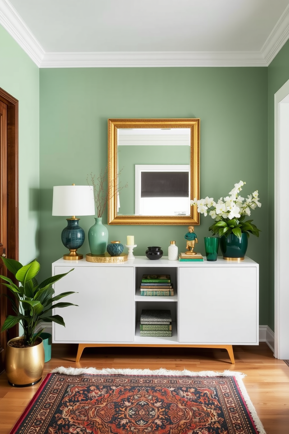 A welcoming foyer adorned with green and gold decorative accents. The walls are painted in a soft green hue, complemented by a stunning gold-framed mirror above a sleek console table. On the console table, a collection of decorative items in various shades of green and gold creates an inviting atmosphere. A plush area rug with intricate patterns adds warmth to the space, while potted plants bring a touch of nature indoors.