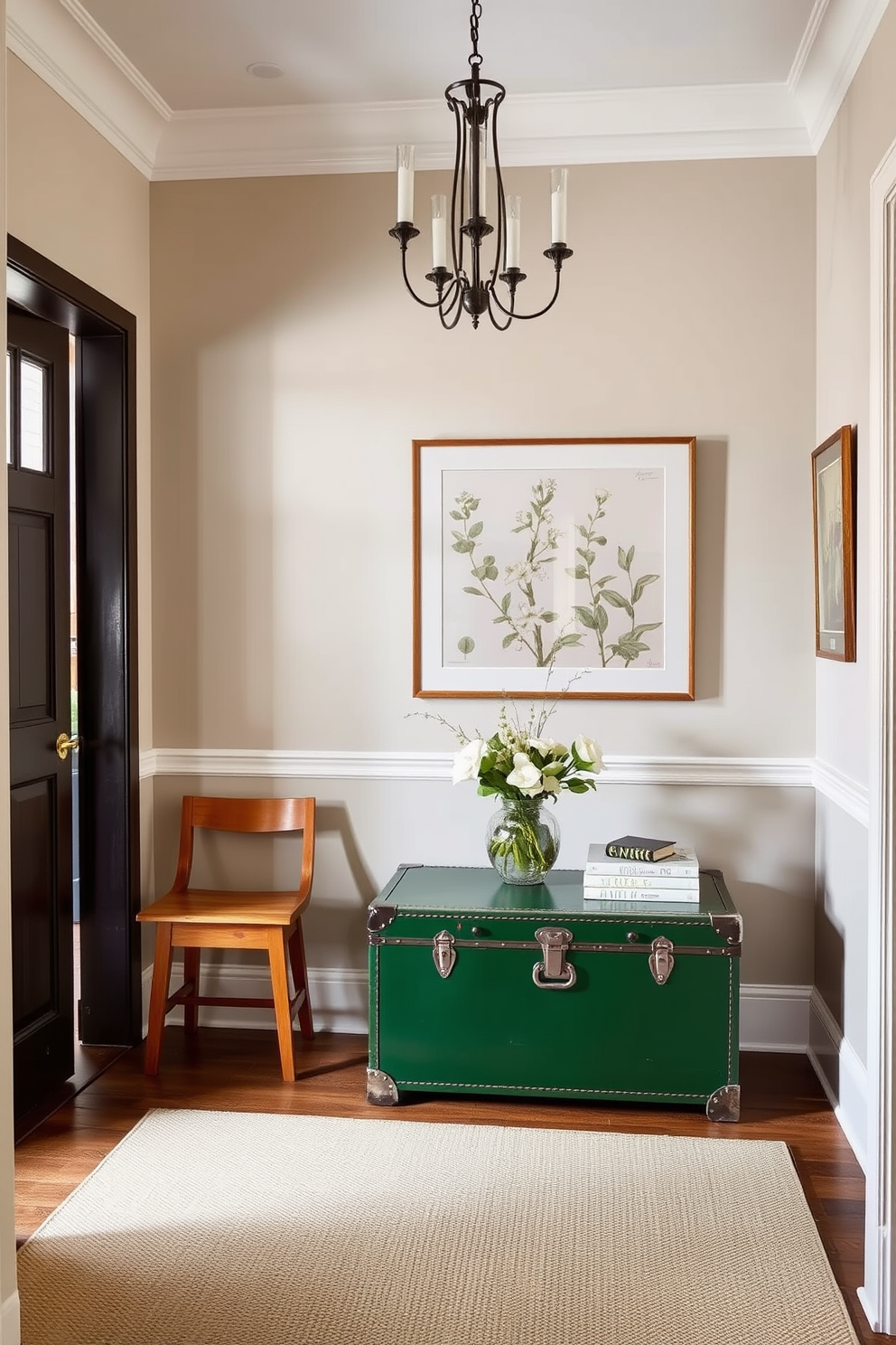 A vintage green trunk serves as a stylish storage solution in the foyer. The trunk is complemented by a warm wooden bench and a series of framed botanical prints on the walls. The foyer features a soft area rug in neutral tones that contrasts beautifully with the green trunk. Elegant lighting fixtures hang from the ceiling, creating a welcoming ambiance.