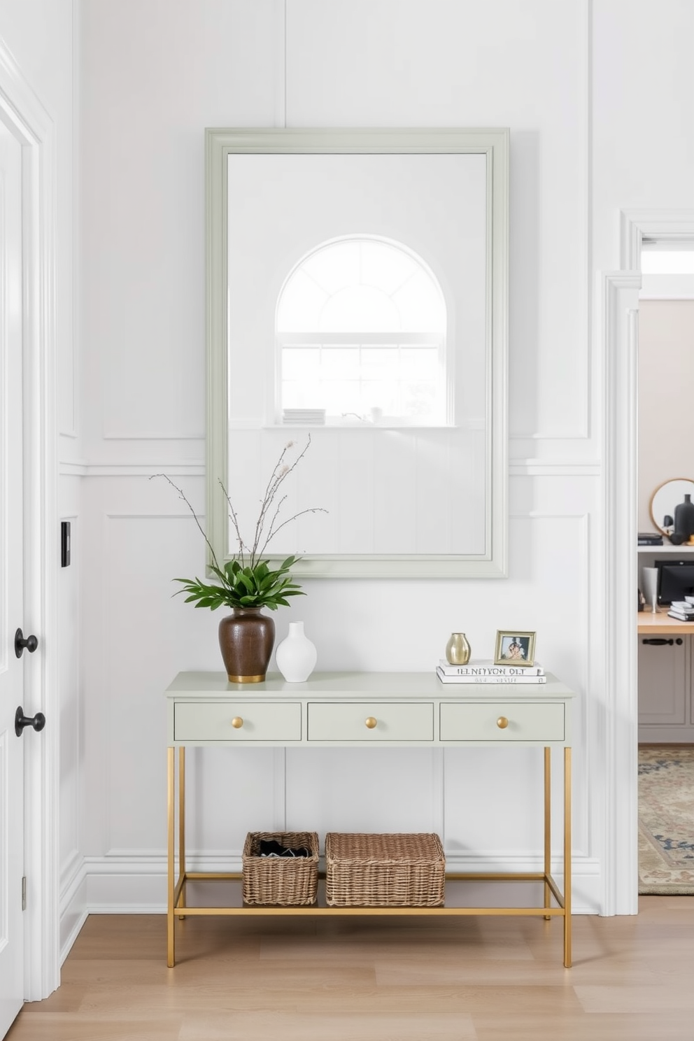 A welcoming foyer features a pale green framed mirror that reflects natural light, enhancing the space's brightness. The walls are adorned with soft white paneling, while a stylish console table sits beneath the mirror, topped with decorative items and a small potted plant.