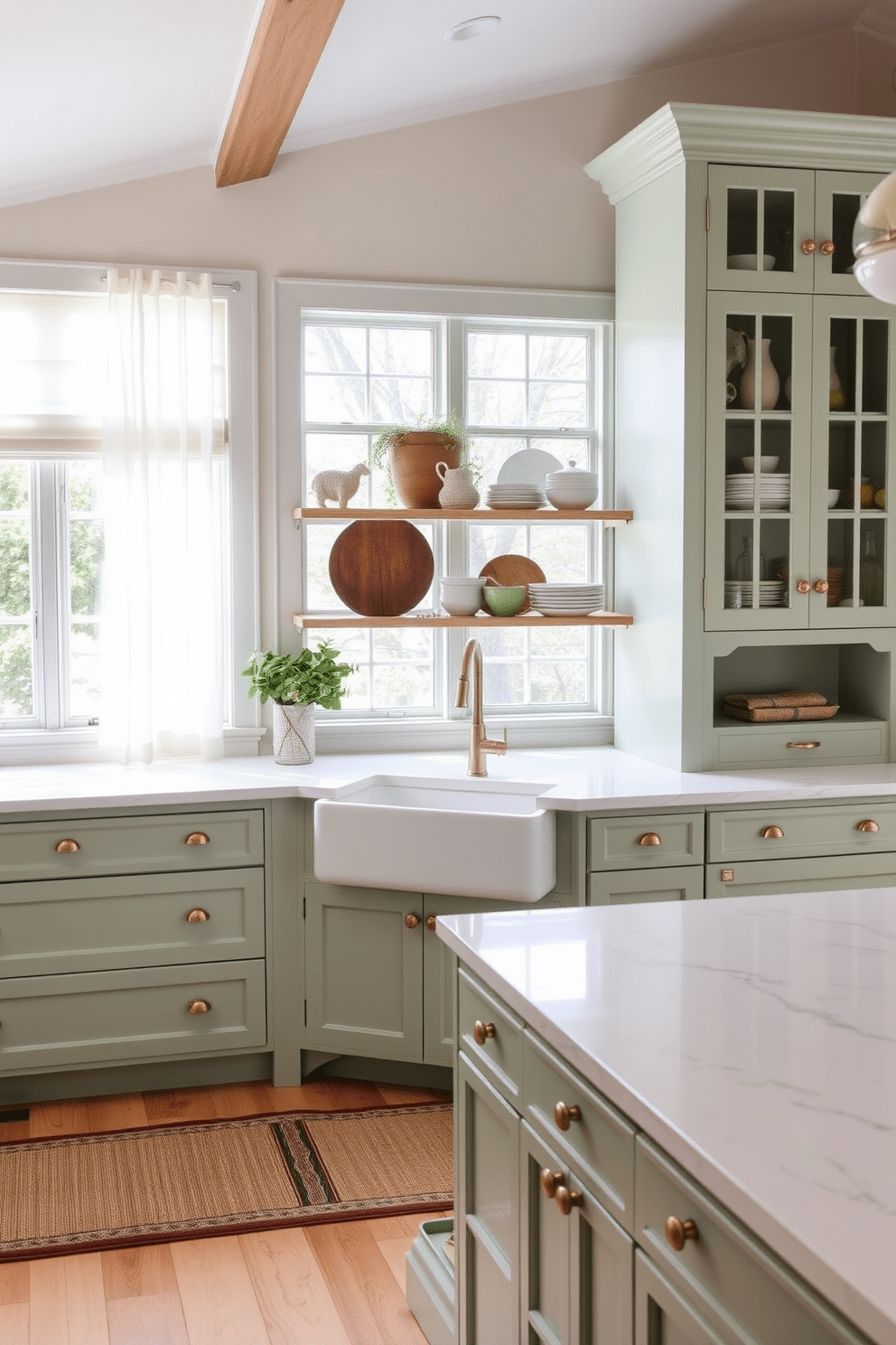 A coastal kitchen featuring soft green tones creates a serene and inviting atmosphere. The cabinets are painted in a pale seafoam green, complemented by white marble countertops and brass hardware. Natural light floods the space through large windows adorned with sheer white curtains. A farmhouse sink sits under the window, surrounded by open shelving displaying rustic dishware and coastal decor.