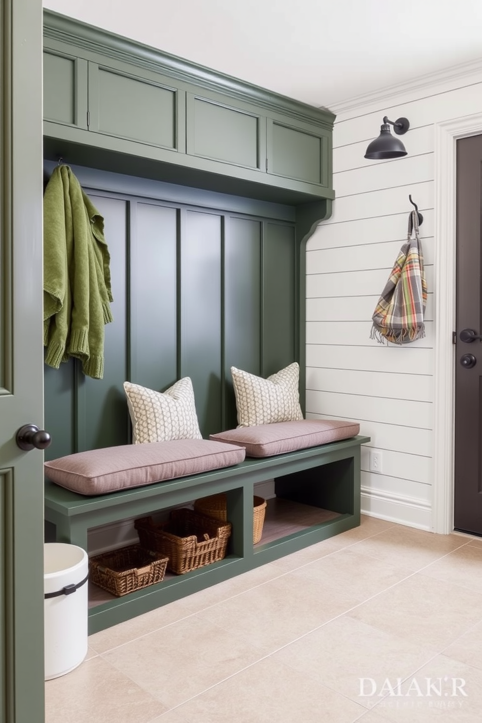 A stylish mudroom featuring a hunter green bench with plush cushion seating. The walls are adorned with shiplap in a light neutral tone, and the floor is covered with durable tile in a complementary shade.