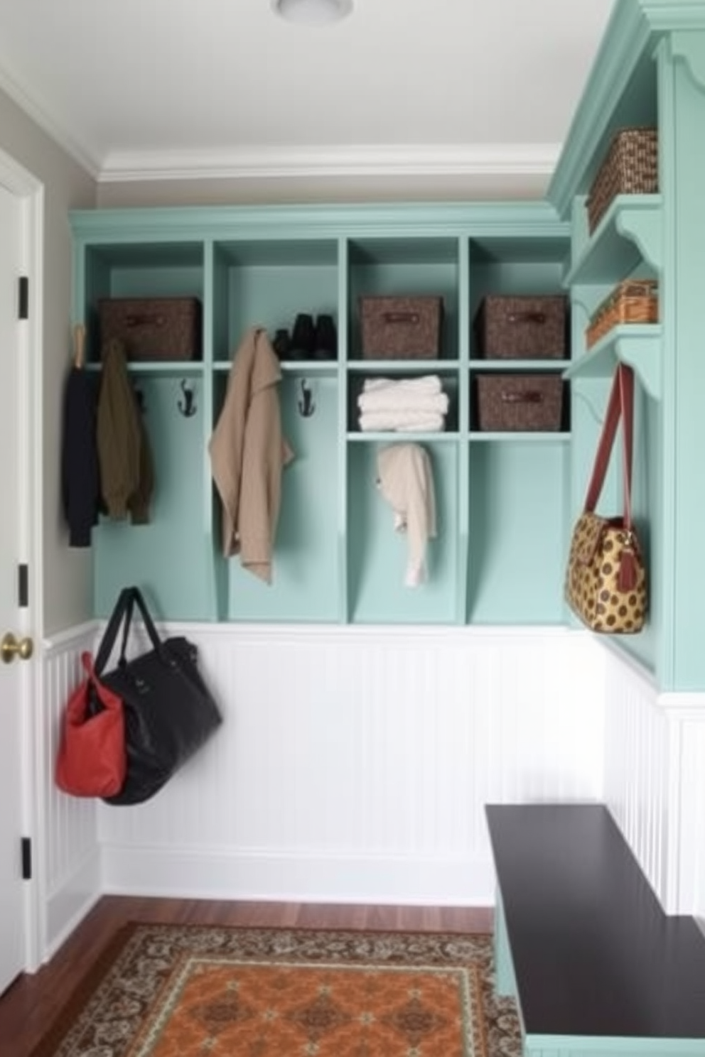 A stylish mudroom features seafoam green wall-mounted shelves that provide ample storage and organization. The space is adorned with hooks for coats and bags, complemented by a patterned rug that adds warmth and character.