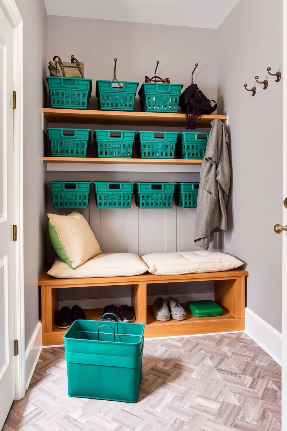 A stylish mudroom featuring emerald green storage baskets neatly arranged on wooden shelves. The walls are painted in a soft grey, complemented by a durable tile floor in a herringbone pattern. A cozy bench with plush cushions sits against the wall, providing a comfortable spot for putting on shoes. Hooks are installed above for hanging coats and bags, enhancing the functionality of the space.