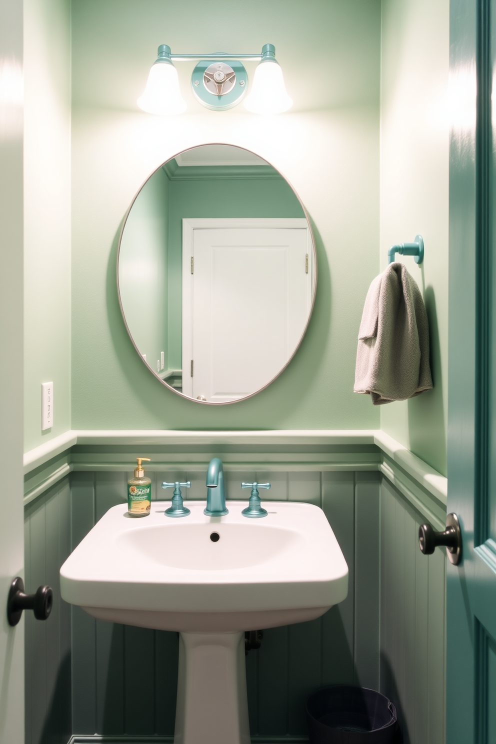 A stylish green powder room featuring teal fixtures and a sleek white sink. The walls are painted a soft green, creating a fresh and inviting atmosphere.