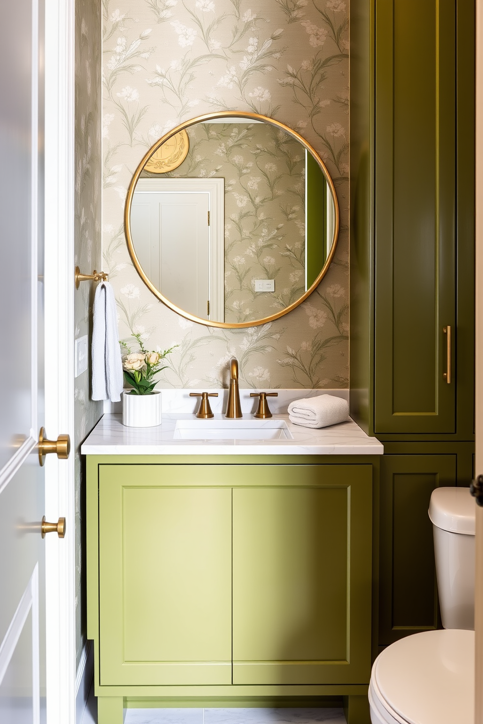 Olive green cabinetry with a sleek marble countertop creates a stunning focal point in the powder room. The walls are adorned with elegant wallpaper featuring subtle floral patterns, enhancing the overall sophistication of the space. A modern round mirror with a brushed gold frame hangs above the sink, reflecting the stylish fixtures. Decorative elements such as a small potted plant and luxurious hand towels add a touch of warmth and comfort to the design.