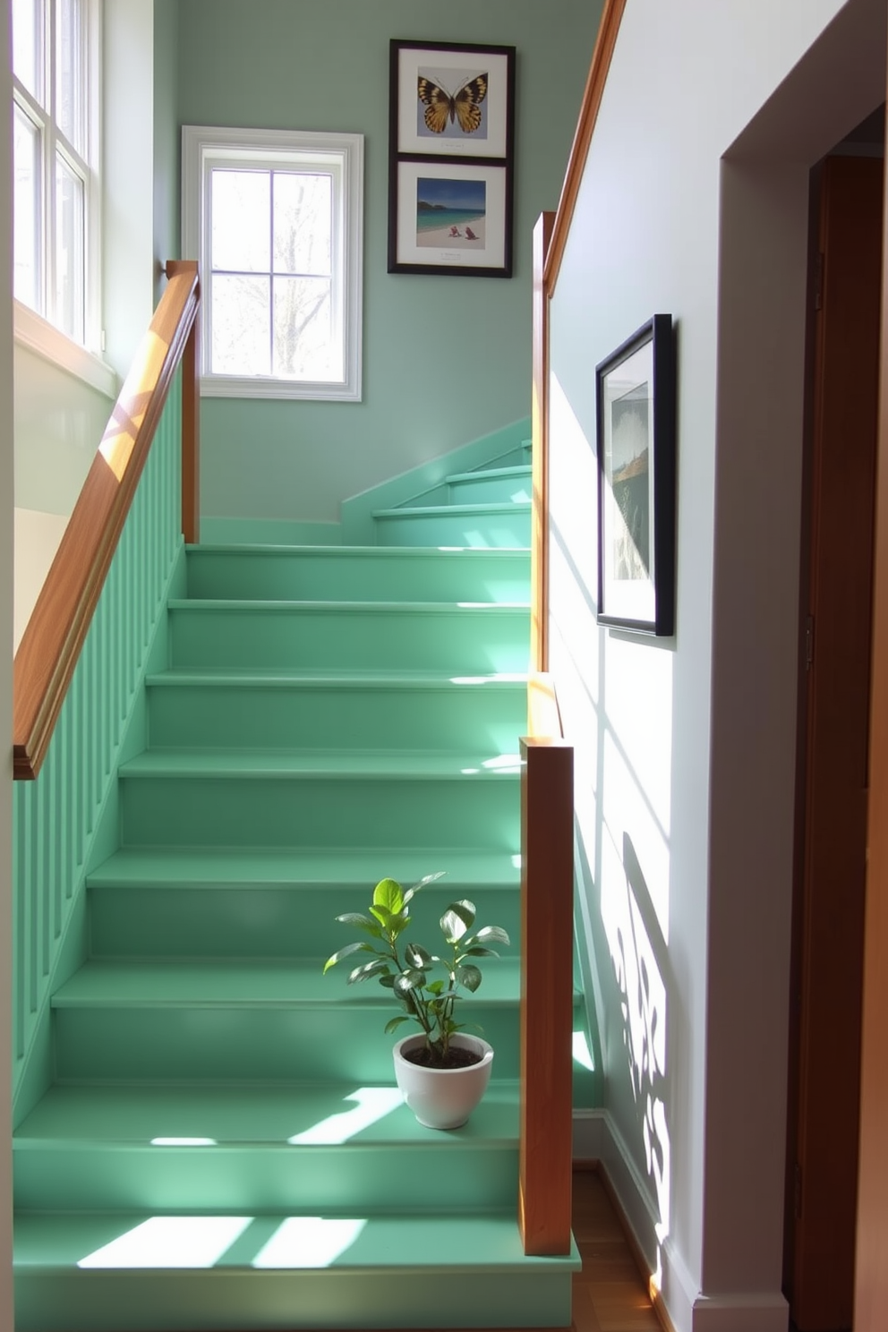 A vibrant seafoam green staircase features a sleek wooden railing that contrasts beautifully with the fresh hue. Natural light floods the space, highlighting the inviting steps and creating a lively atmosphere. The walls adjacent to the staircase are adorned with framed artwork that complements the seafoam green. A small potted plant sits at the base of the stairs, adding a touch of nature to the design.