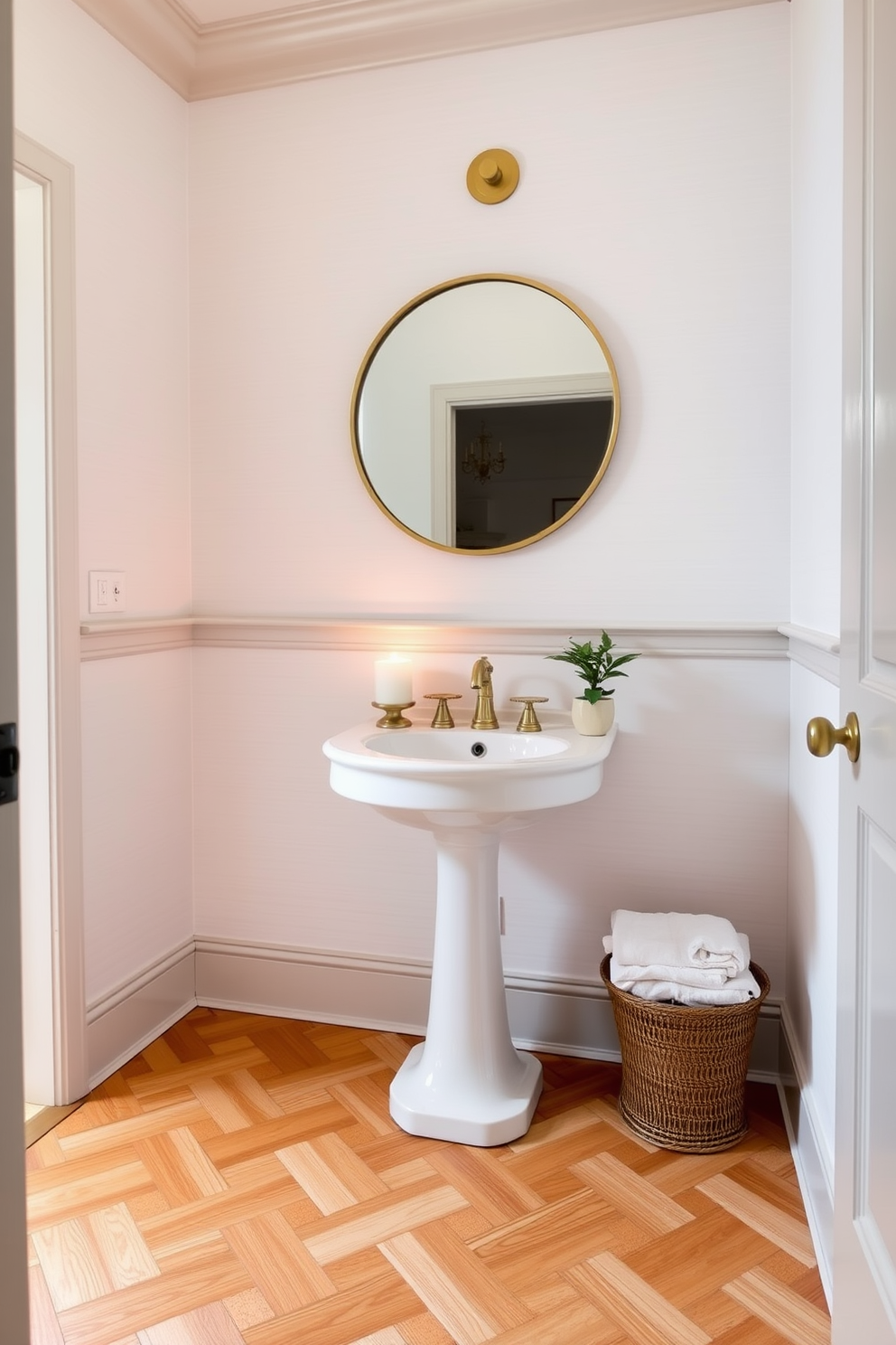 A stylish half bath with elegant candle holders positioned on the countertop to create soft ambient lighting. The walls are adorned with subtle wallpaper in a light pastel hue, and the flooring features a classic herringbone pattern in warm wood tones. The space includes a chic pedestal sink complemented by a round mirror with a vintage brass frame. Decorative elements such as a small potted plant and neatly folded towels enhance the inviting atmosphere of the powder room.