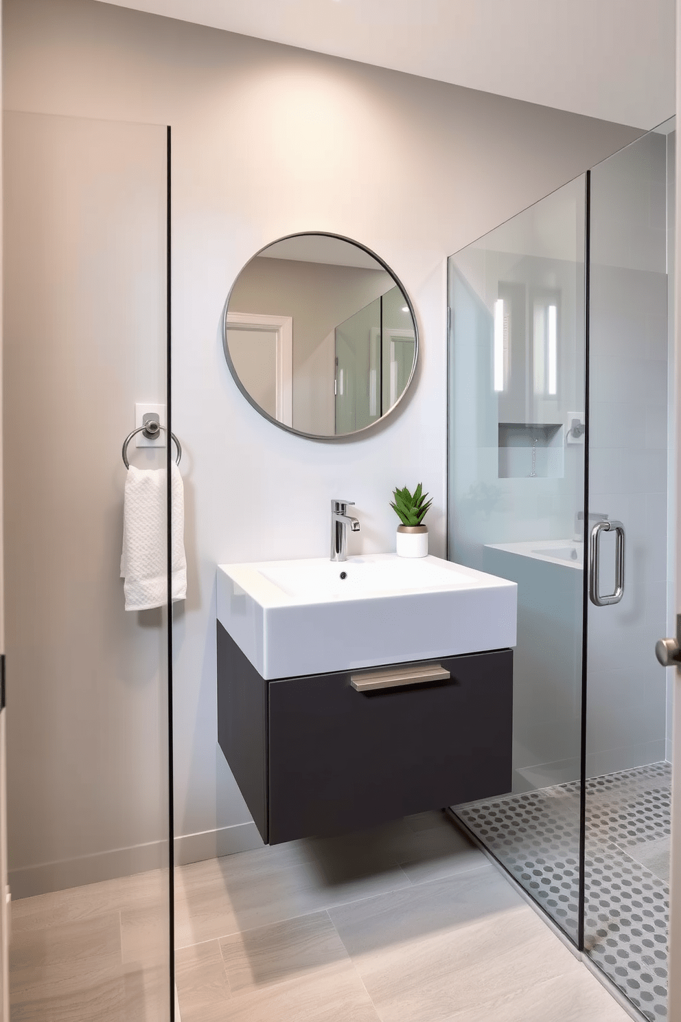 A stylish half bathroom featuring a glass shower enclosure that enhances the sense of openness. The space is adorned with a sleek floating vanity topped with a quartz countertop and a modern round mirror above it. The walls are painted in a soft gray to create a calming atmosphere. Elegant fixtures in brushed nickel complement the overall design, while a tasteful potted plant adds a touch of greenery.