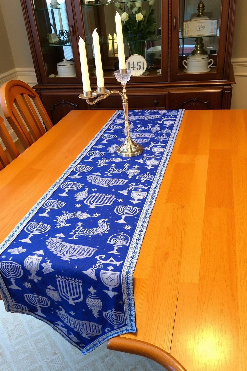 A beautiful dining table adorned with a table runner featuring festive patterns inspired by Hanukkah. The runner is rich in blue and silver hues, showcasing menorahs and dreidels, creating a warm and inviting atmosphere for family gatherings.