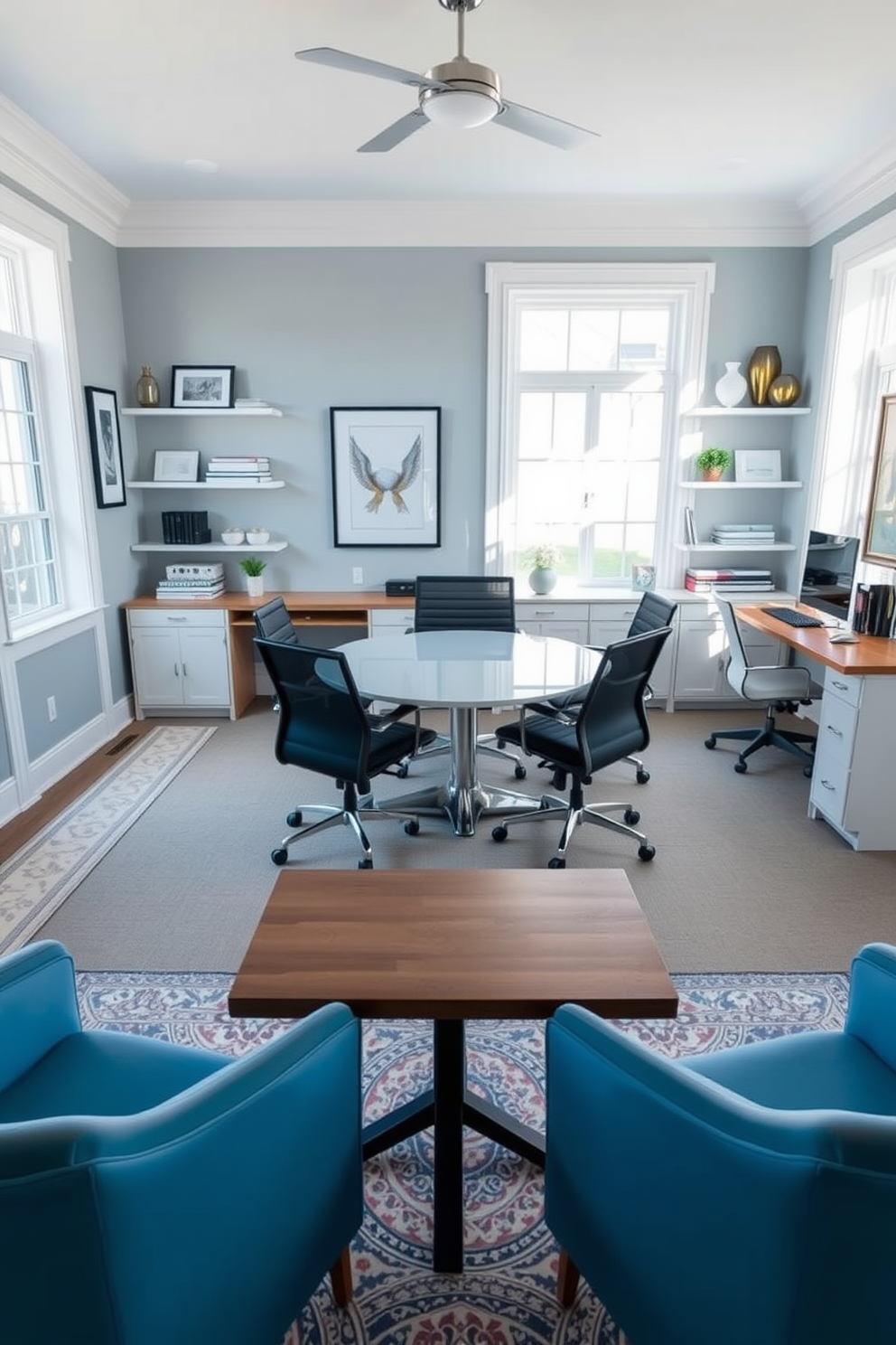 A stylish home office featuring a small conference table in the center, surrounded by comfortable ergonomic chairs. The room is designed with a calming color palette of soft blues and whites, complemented by natural light streaming through large windows. On one side of the room, a sleek wooden desk is paired with a modern task chair, creating a functional workspace. The walls are adorned with framed artwork and shelves filled with books and decorative items, adding personality to the space.