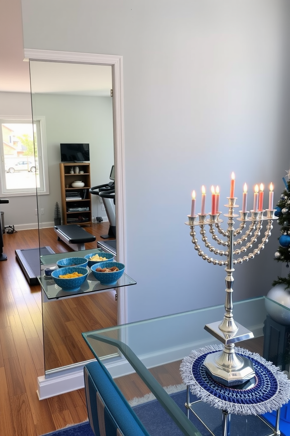 A cozy home gym setting. The space features a large window allowing natural light to flood in, with wooden flooring and a wall-mounted mirror reflecting the workout area. Decorative bowls filled with healthy snacks are placed on a sleek, modern shelf. The walls are painted in a calming light blue, creating an inviting atmosphere for exercise. A festive Hanukkah decorating theme is evident throughout the room. Blue and silver accents are incorporated, with a beautifully adorned menorah as the focal point on a well-lit table.