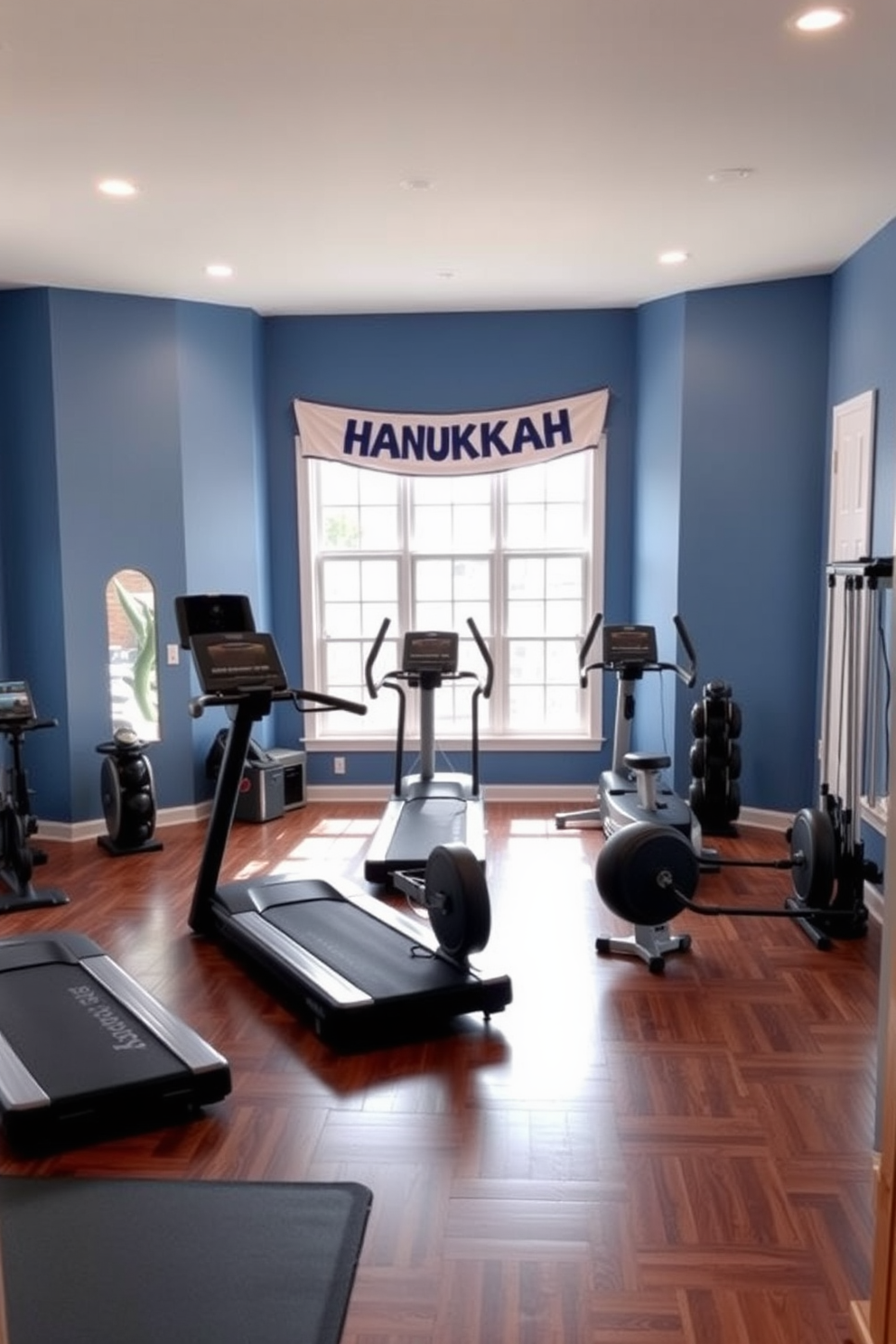 A modern home gym featuring a spacious layout with exercise equipment neatly arranged. The walls are painted in a calming blue color, and a Hanukkah banner hangs across one wall, adding a festive touch to the space. The flooring is made of dark hardwood, providing a warm contrast to the bright decor. Large windows allow natural light to flood the room, enhancing the vibrant atmosphere and motivating workouts.