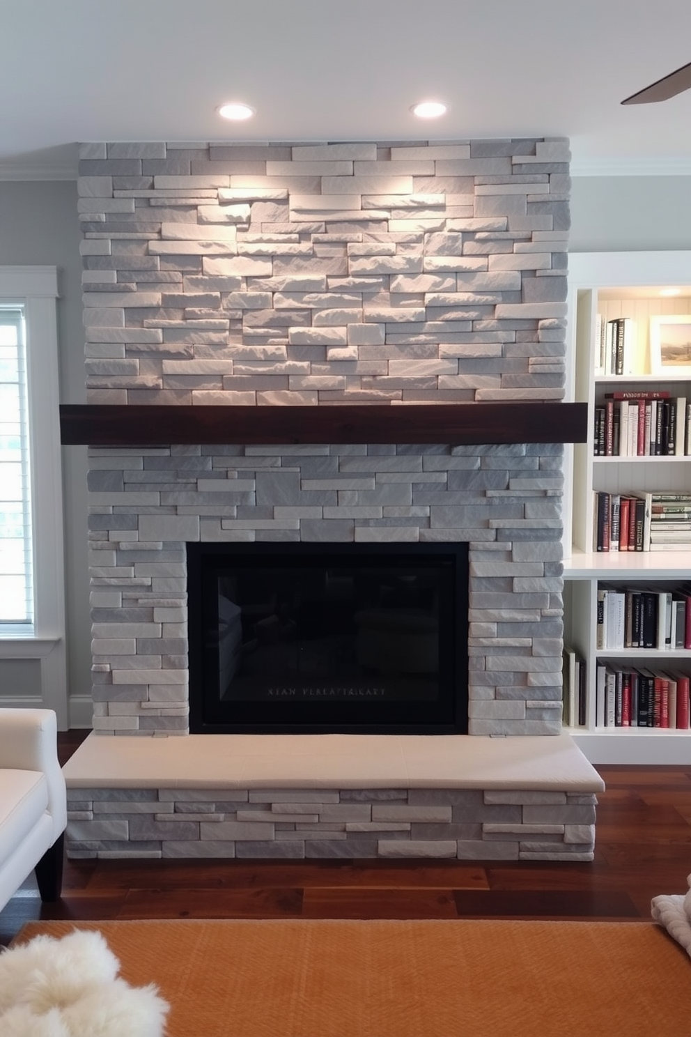 A cozy fireplace with a modern stone facade is the focal point of the room. The stone is a mix of gray and white tones, creating a sleek and contemporary look that complements the surrounding decor. Adjacent to the fireplace, a home library features custom-built shelves filled with books. Plush seating and a warm rug create an inviting atmosphere for reading and relaxation.