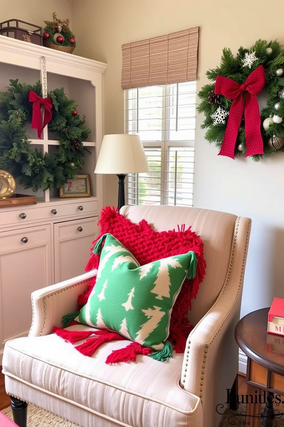 A cozy home office decorated for Christmas. A comfortable chair is adorned with red and green throw pillows, creating a festive and inviting atmosphere.