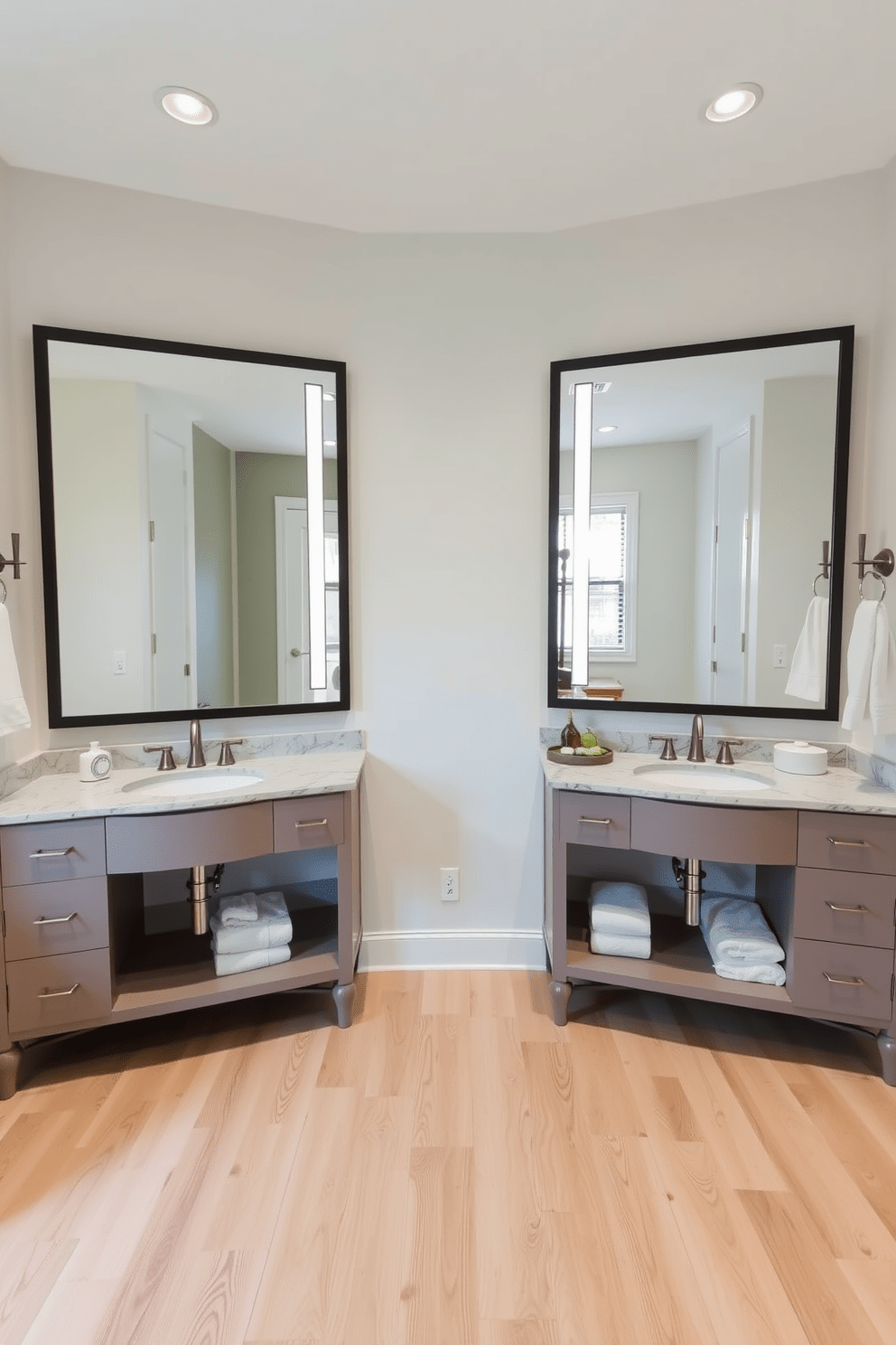 A Jack and Jill bathroom features two separate vanities with stylish sinks positioned between two floor-to-ceiling mirrors that enhance the sense of space. The walls are painted in a soft neutral tone, while the flooring is a light wood that adds warmth and elegance to the design.