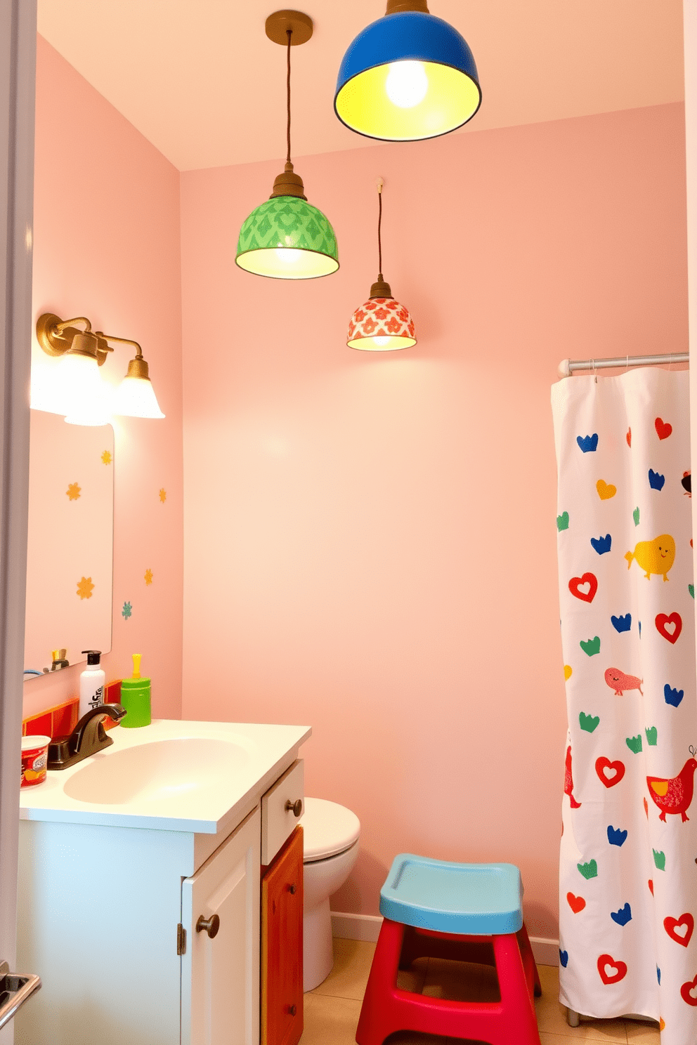 Playful lighting fixtures hang from the ceiling, casting a warm glow throughout the space. The room features colorful wall decals and a fun shower curtain that adds a whimsical touch. The vanity is designed with bright colors and playful shapes, perfect for children. A sturdy step stool is placed next to the sink to encourage independence while brushing teeth.