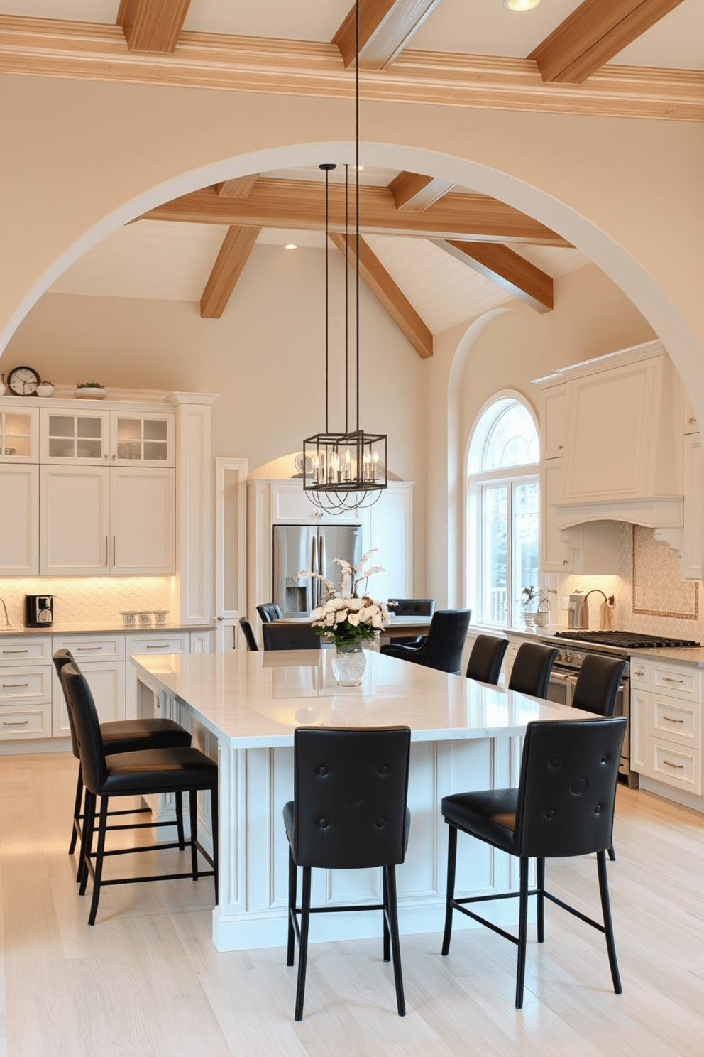 An open concept kitchen featuring a spacious layout that seamlessly connects to the dining area. The kitchen island is topped with a sleek quartz surface and surrounded by high-backed bar stools. The arched transition between the kitchen and dining space is elegantly designed with decorative molding and warm lighting. This inviting space is adorned with soft neutral tones and modern appliances that enhance its functionality and aesthetic appeal.