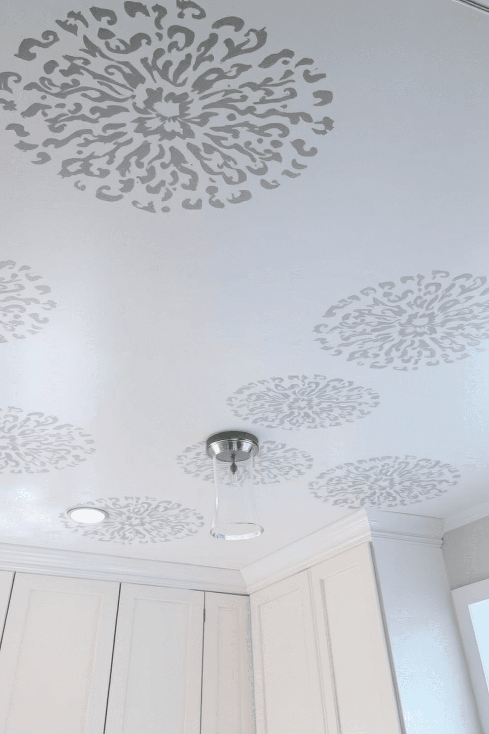 A stenciled ceiling adds a unique artistic flair to the kitchen space. The intricate patterns create a stunning focal point that enhances the overall design aesthetic. Consider using a soft color palette to complement the stenciling. This approach ensures that the ceiling becomes a harmonious part of the kitchen's decor while remaining visually striking.