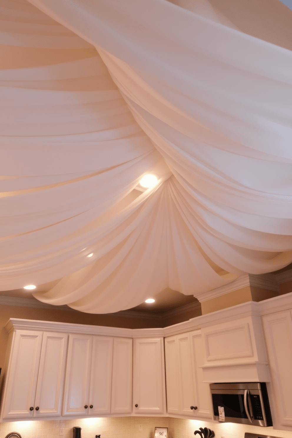 A kitchen ceiling adorned with a fabric draped design creates a soft and inviting atmosphere. The gentle folds of the fabric add texture and warmth, enhancing the overall aesthetic of the space. The color of the fabric complements the cabinetry and countertops, tying the design elements together. Soft lighting fixtures are integrated into the fabric, casting a warm glow throughout the kitchen.