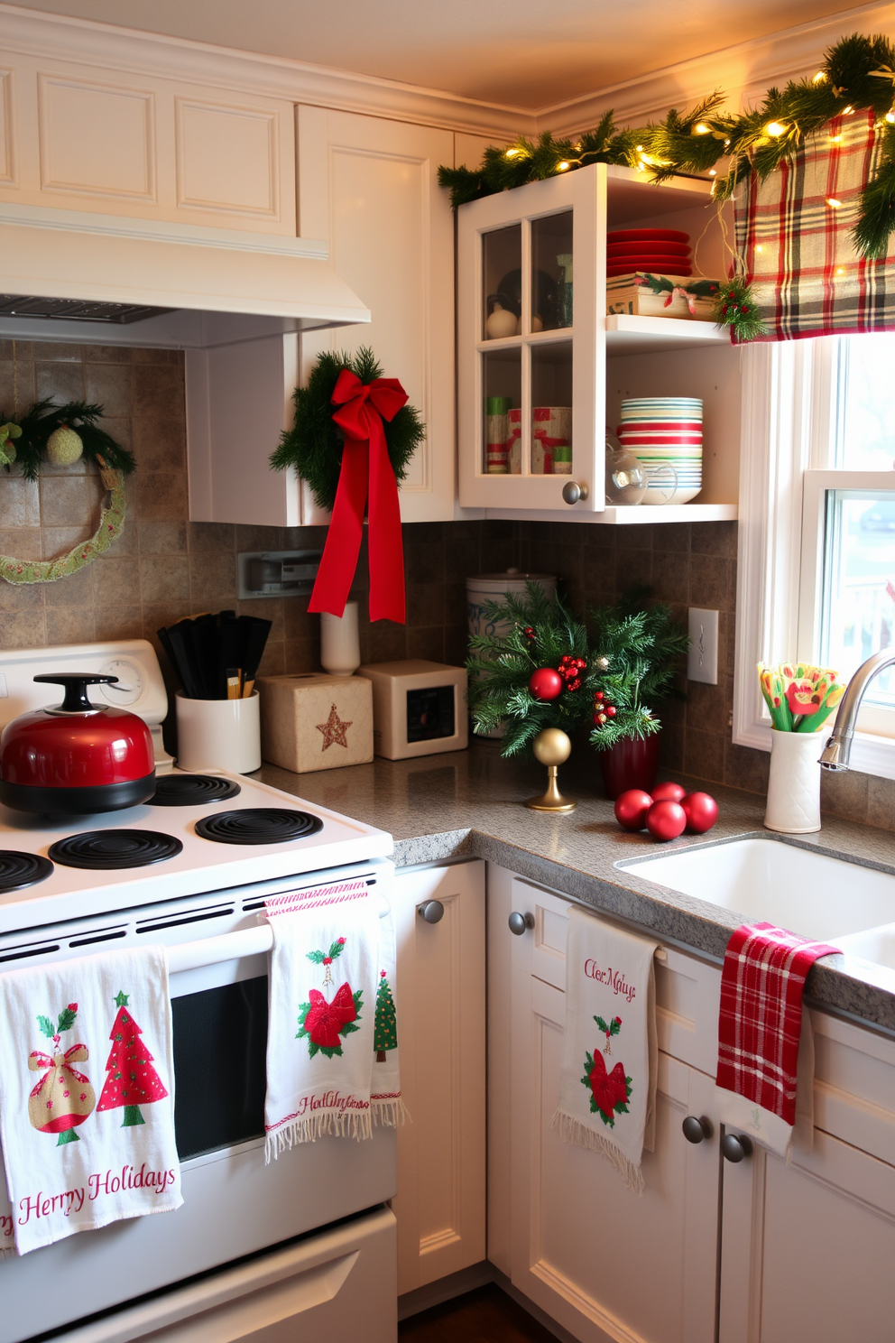 A cozy kitchen adorned for the holiday season. Festive dish towels with Christmas motifs hang from the oven and sink, complementing the warm red and green color scheme throughout the space. The countertops are adorned with seasonal decorations, including a centerpiece of pine branches and ornaments. Twinkling fairy lights are draped along the window sill, adding a cheerful glow to the festive atmosphere.